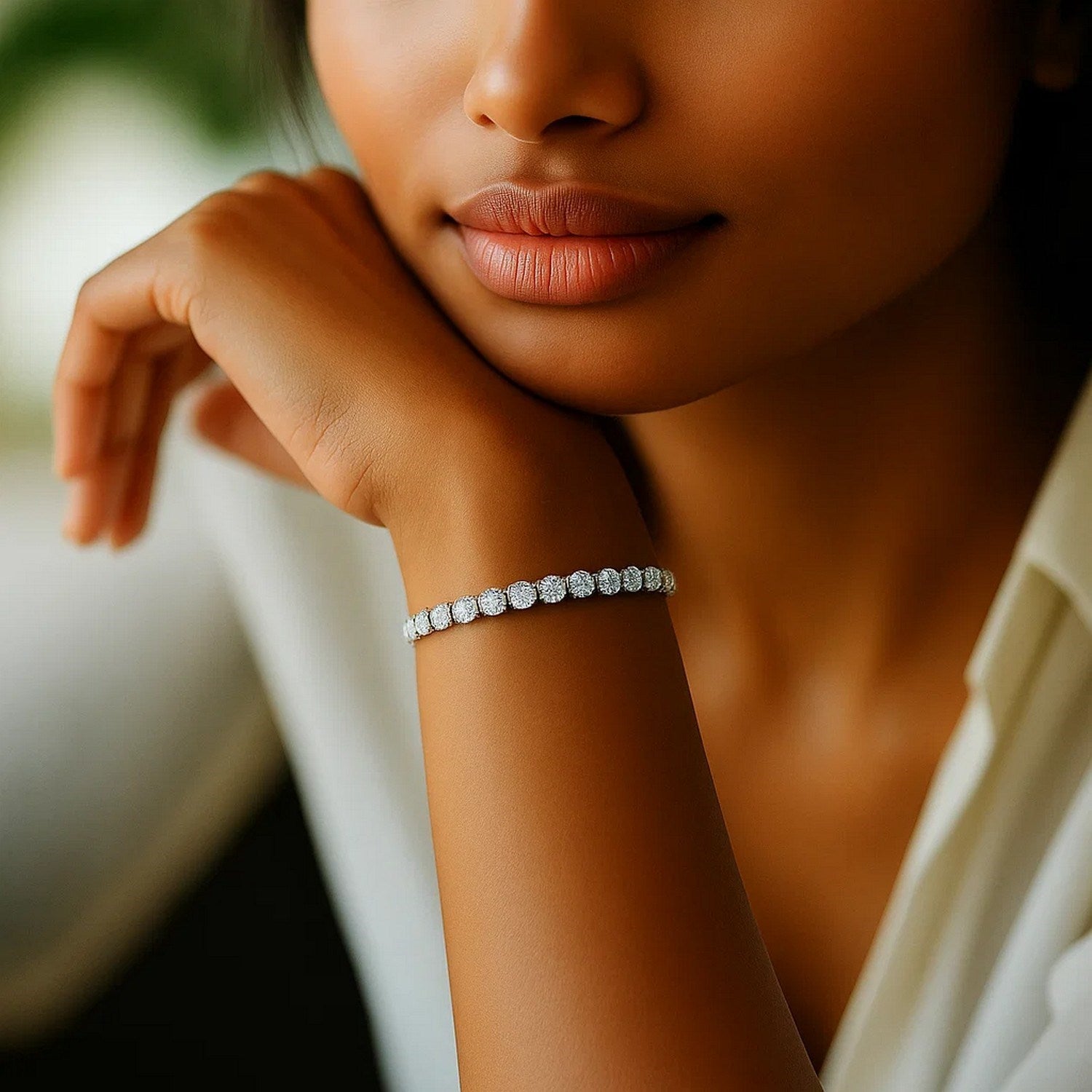 A woman wears a lab grown round diamond tennis bracelet in 14k white gold.