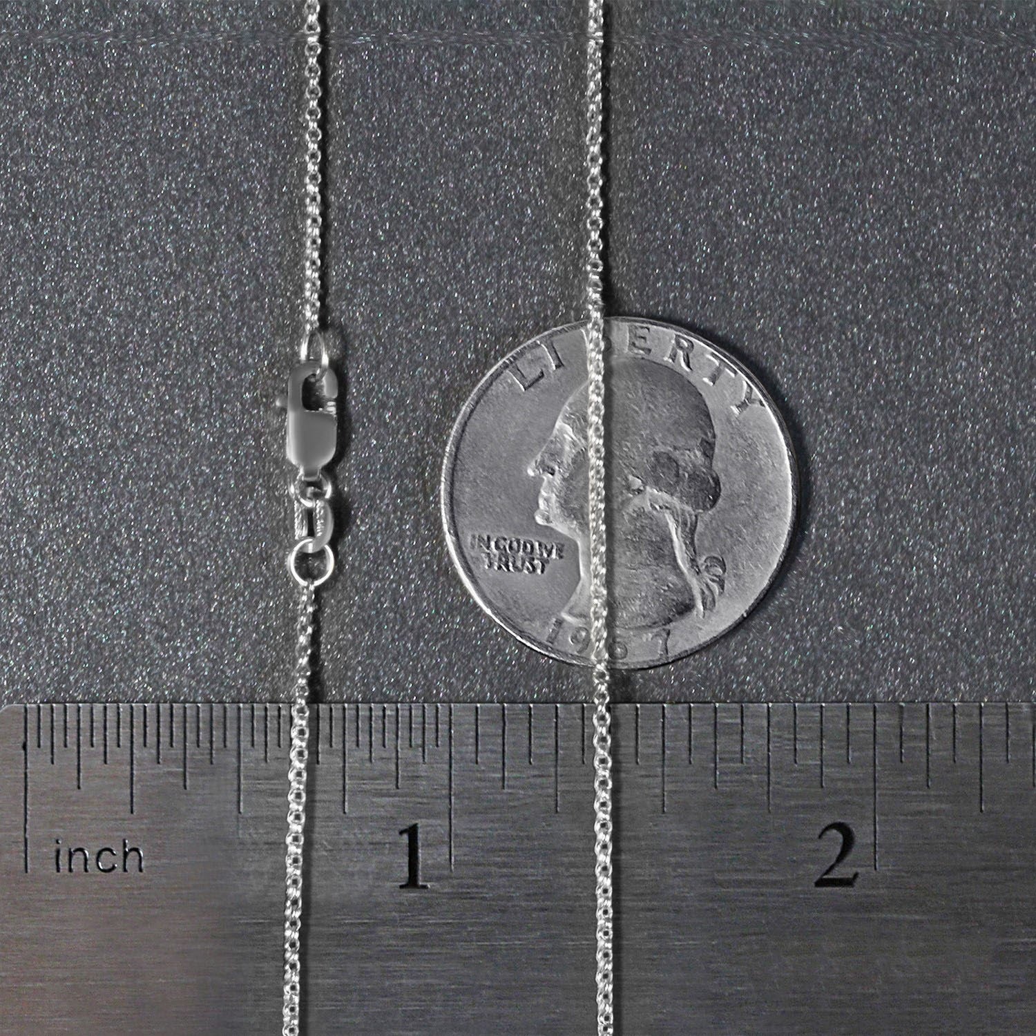 A 14k white gold diamond cut rolo chain with a lobster clasp, shown next to a ruler and quarter for scale.