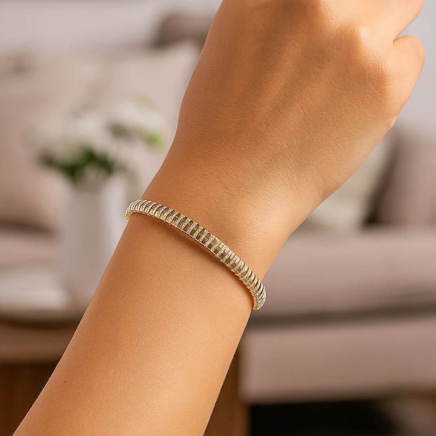 A 14K two-tone gold mini diamante bracelet on a person's wrist.