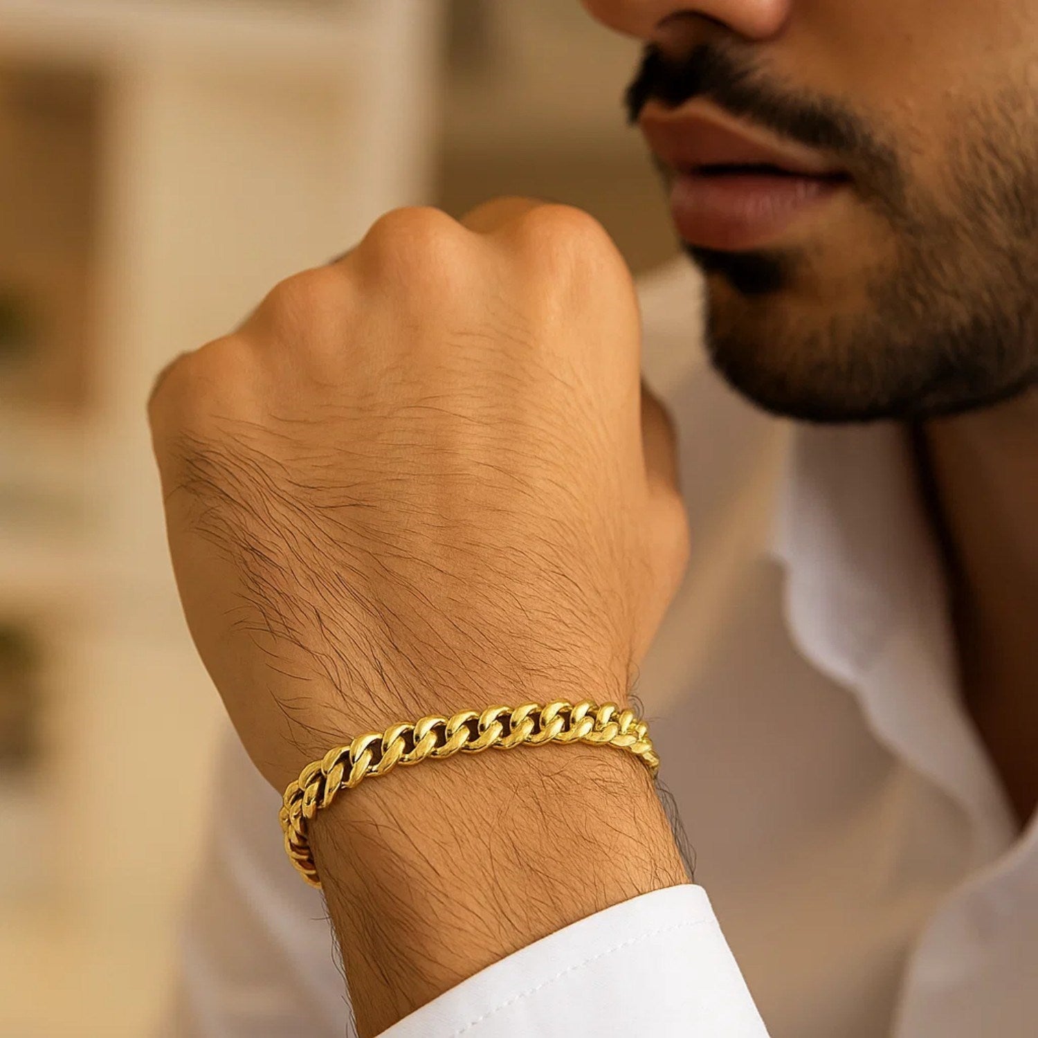 14k yellow gold classic Miami Cuban solid bracelet on a man's wrist.