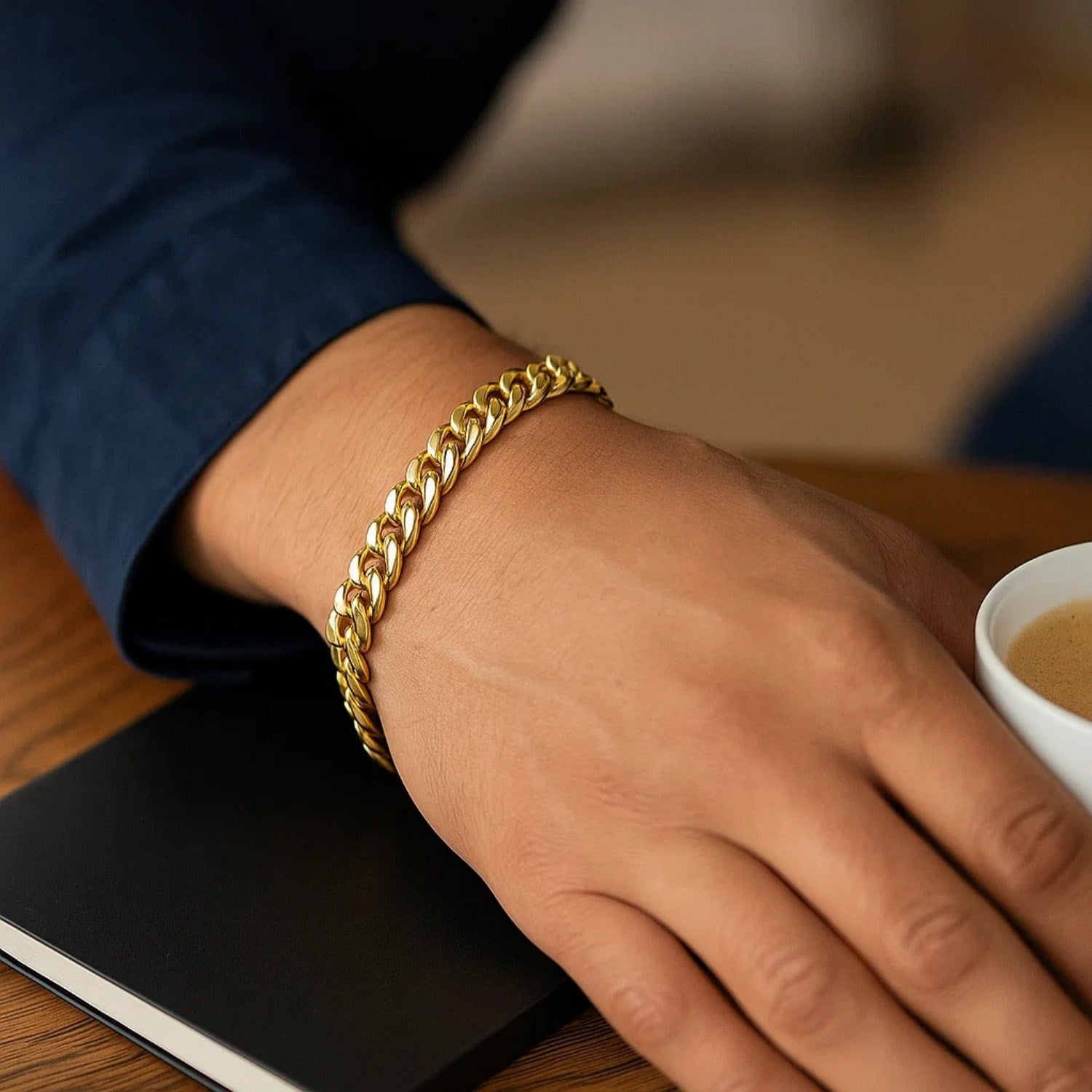 14k yellow gold classic Miami Cuban solid bracelet on a person's wrist.