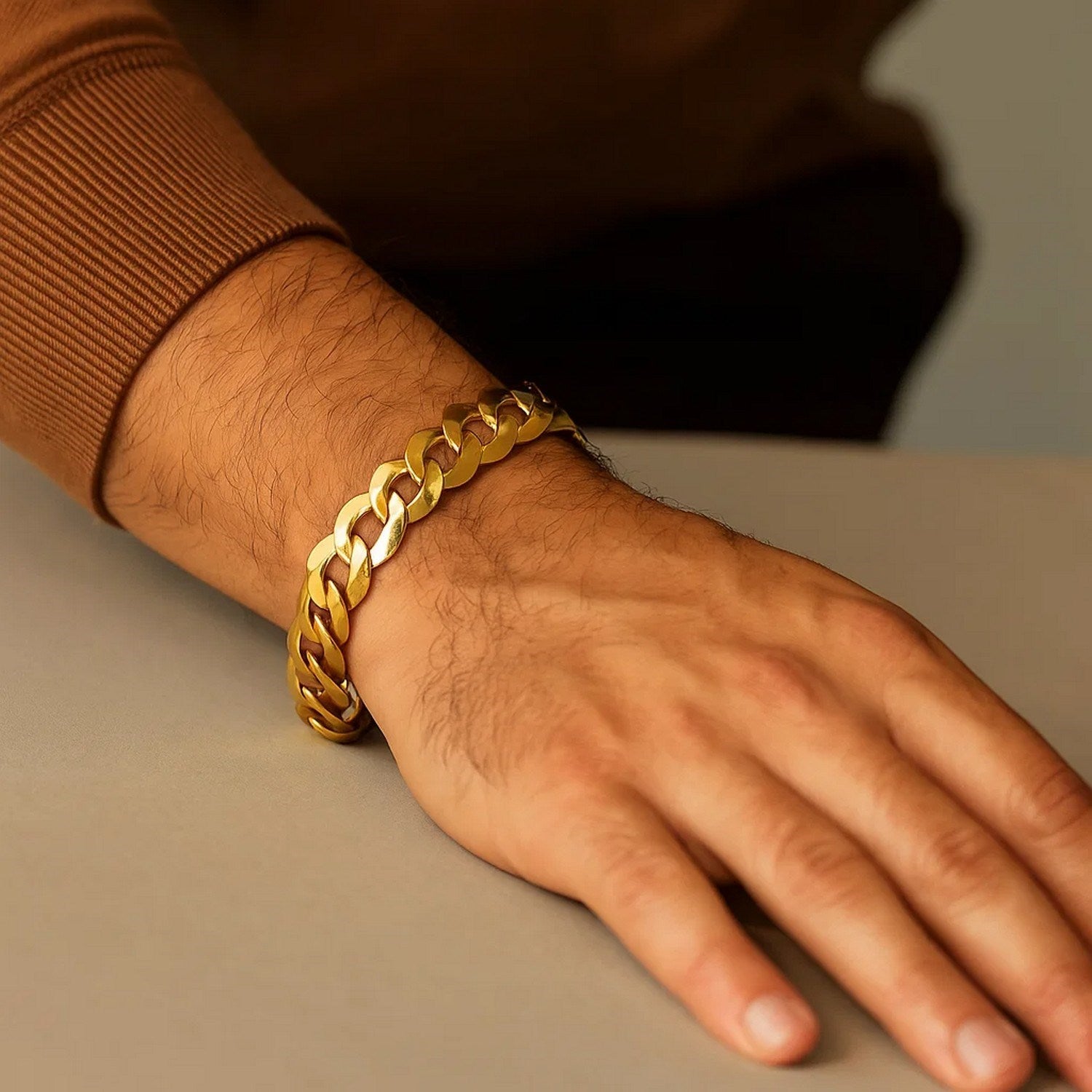14k yellow gold solid curb bracelet on a man's wrist.