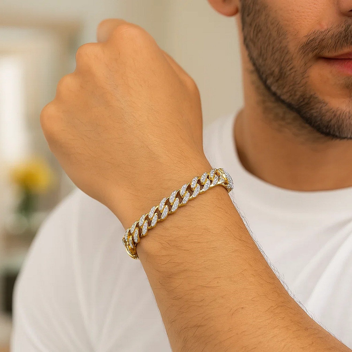 14k yellow gold Miami Cuban bracelet with white pave on a man's wrist.