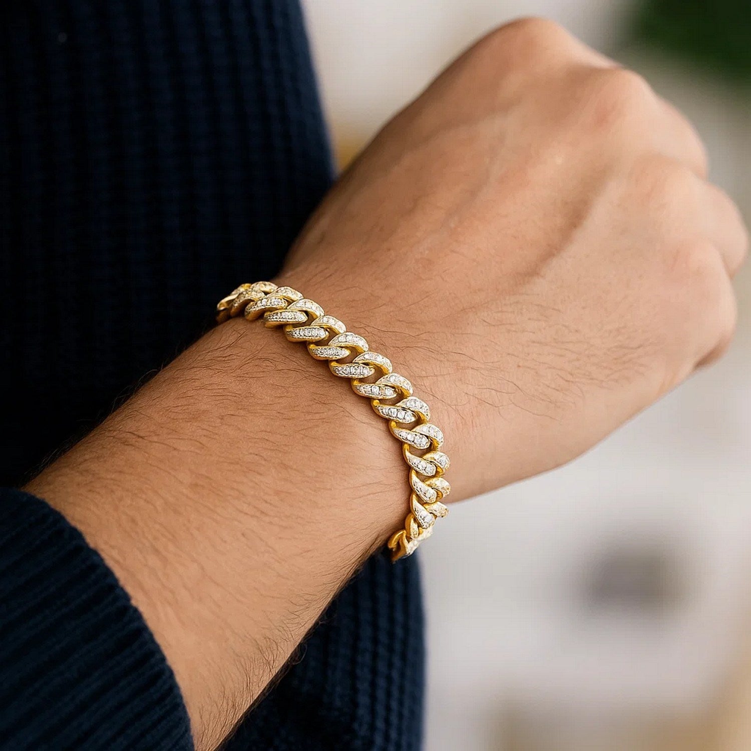 14k yellow gold Miami Cuban bracelet with white pave diamonds on a man's wrist.