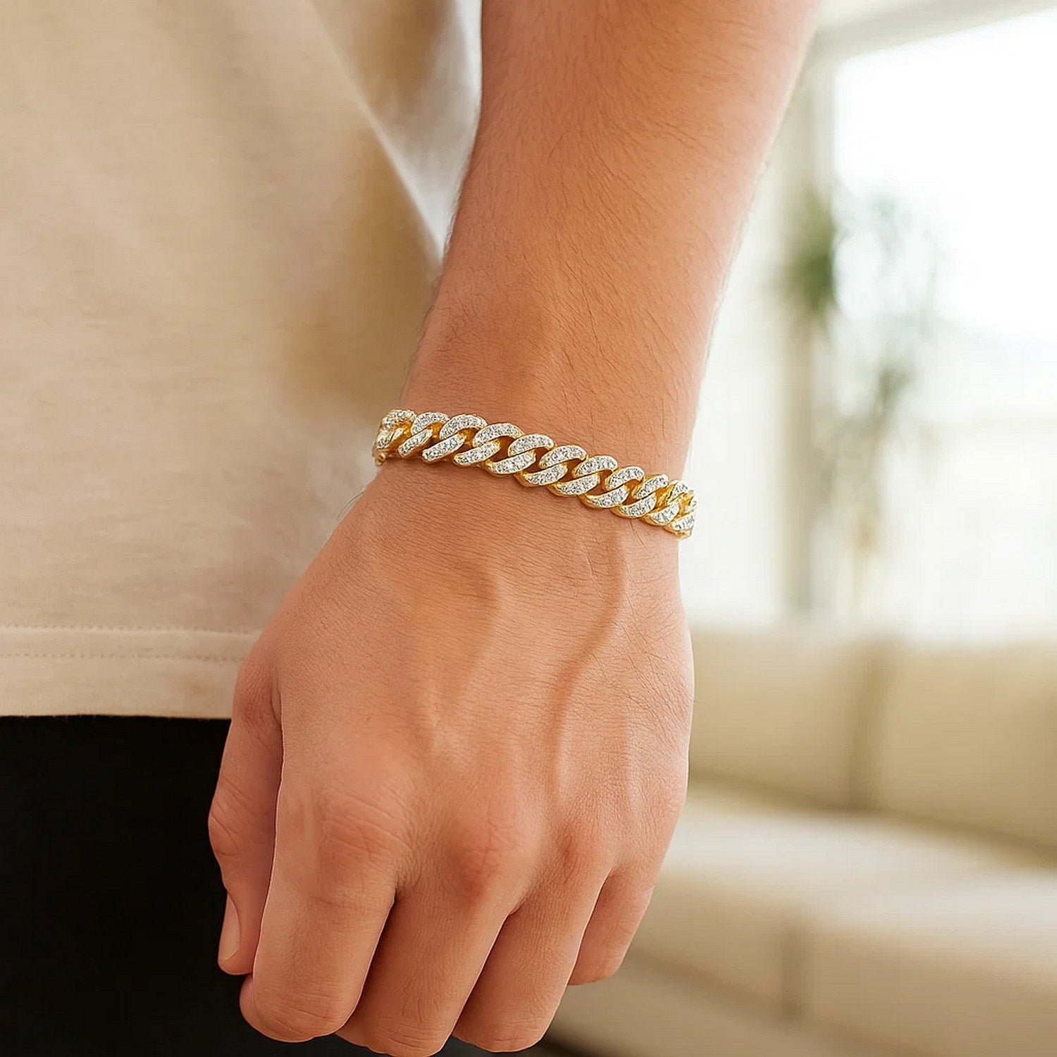 14k yellow gold Miami Cuban bracelet with white pave on a person's wrist.