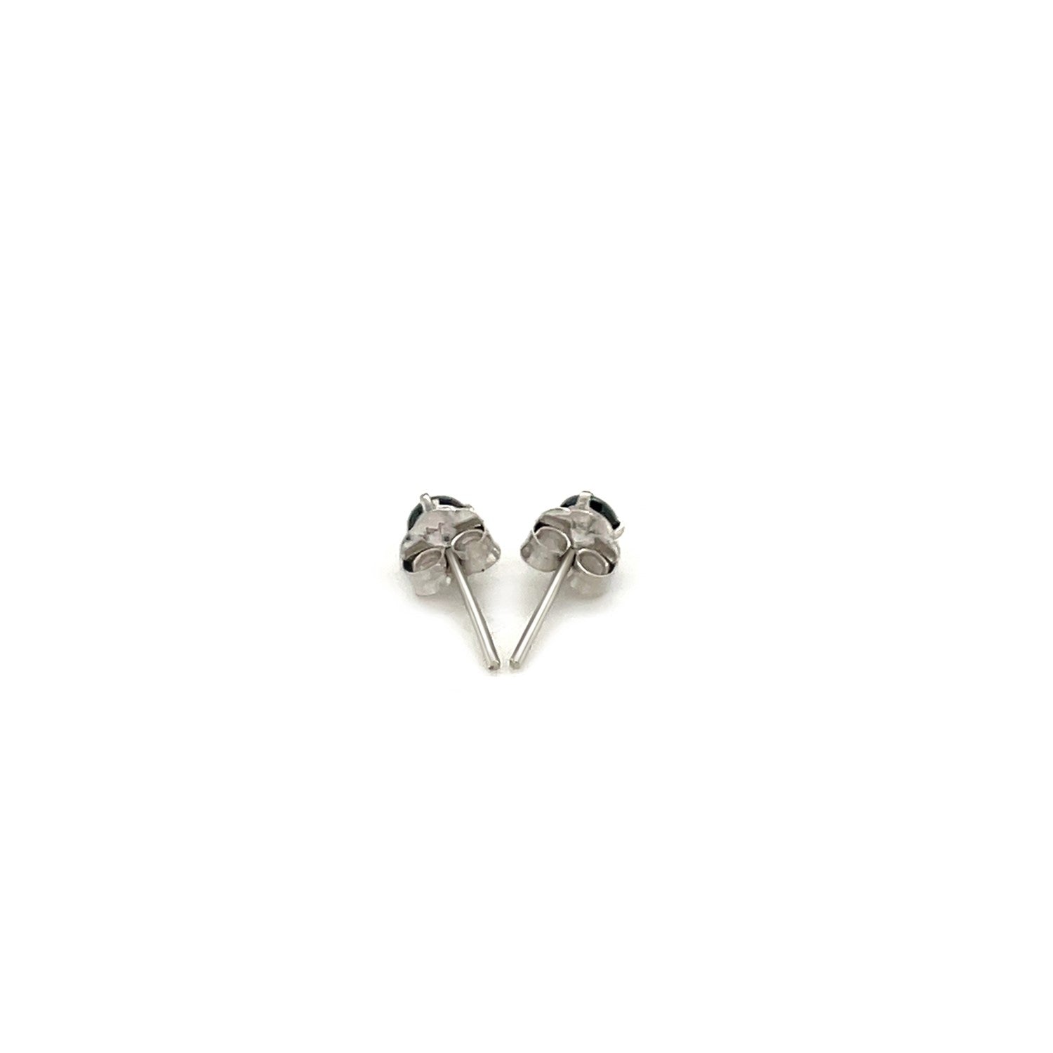 A pair of 14k white gold stud earrings with black cubic zirconia.