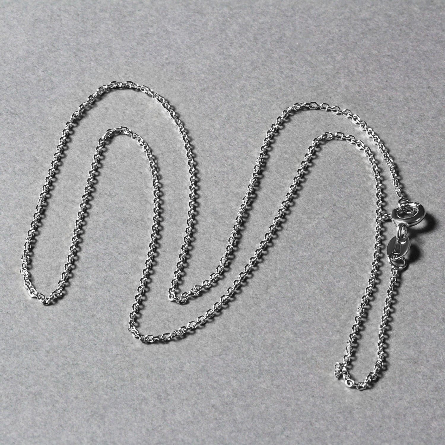 18k white gold diamond cut cable link chain with a spring ring clasp.