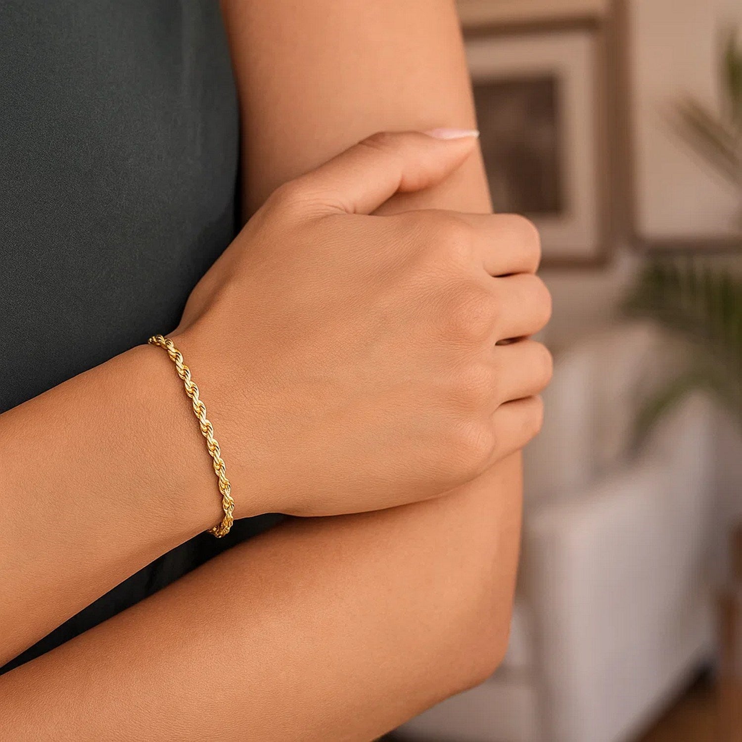 A 10k yellow gold solid diamond cut rope bracelet on a person's wrist.