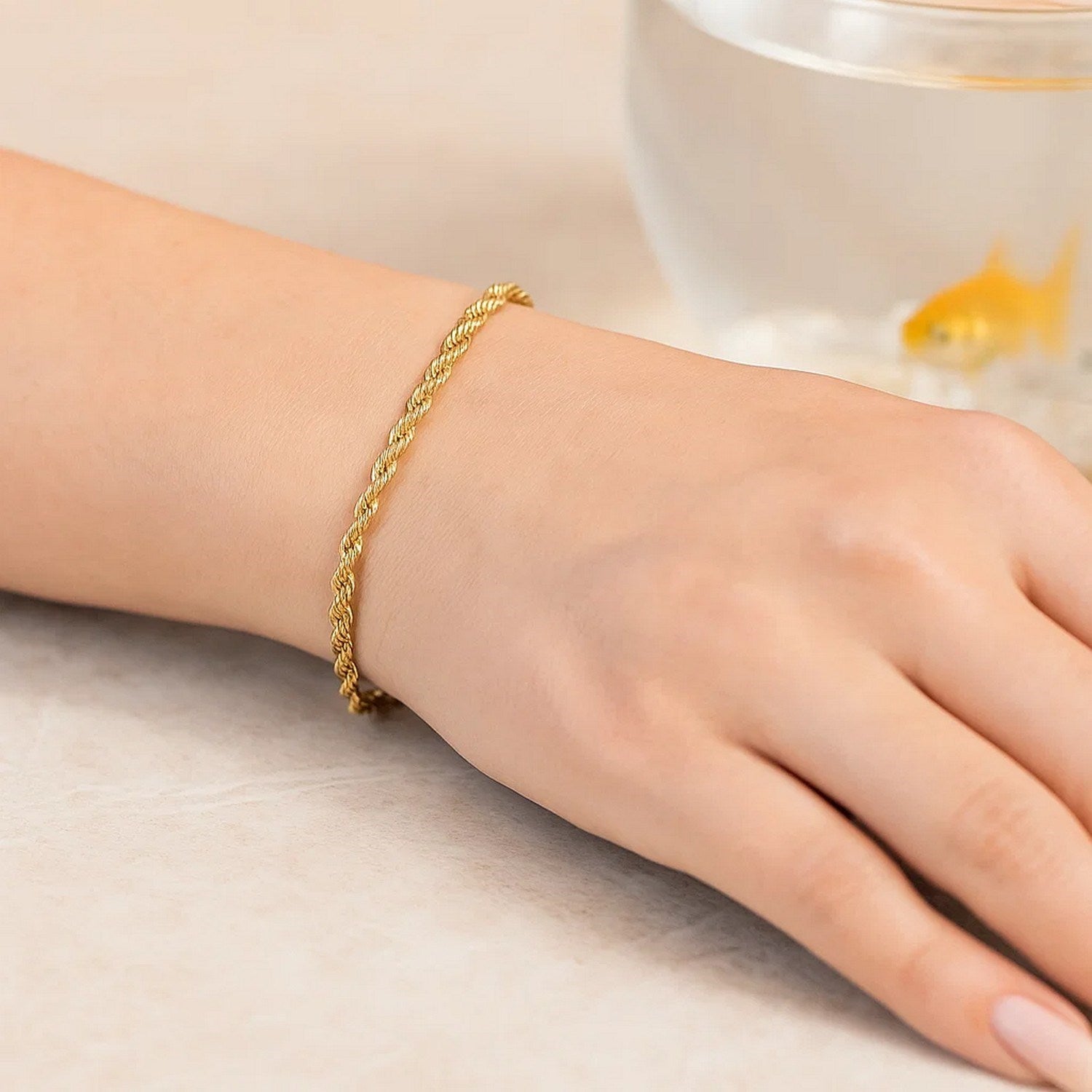 A 10k yellow gold solid diamond cut rope bracelet on a person's wrist.