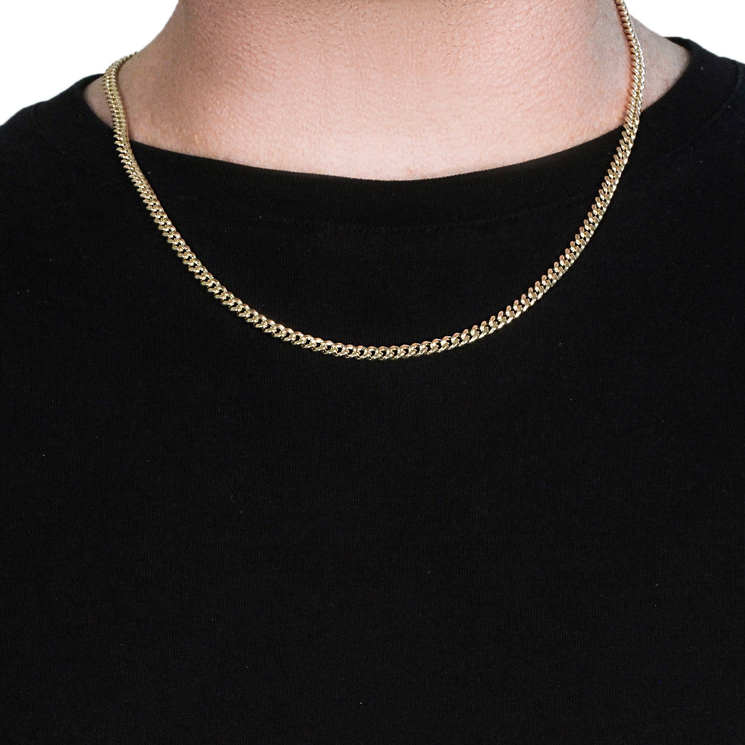 A 14k yellow gold semi-solid Miami Cuban chain on a person's neck.