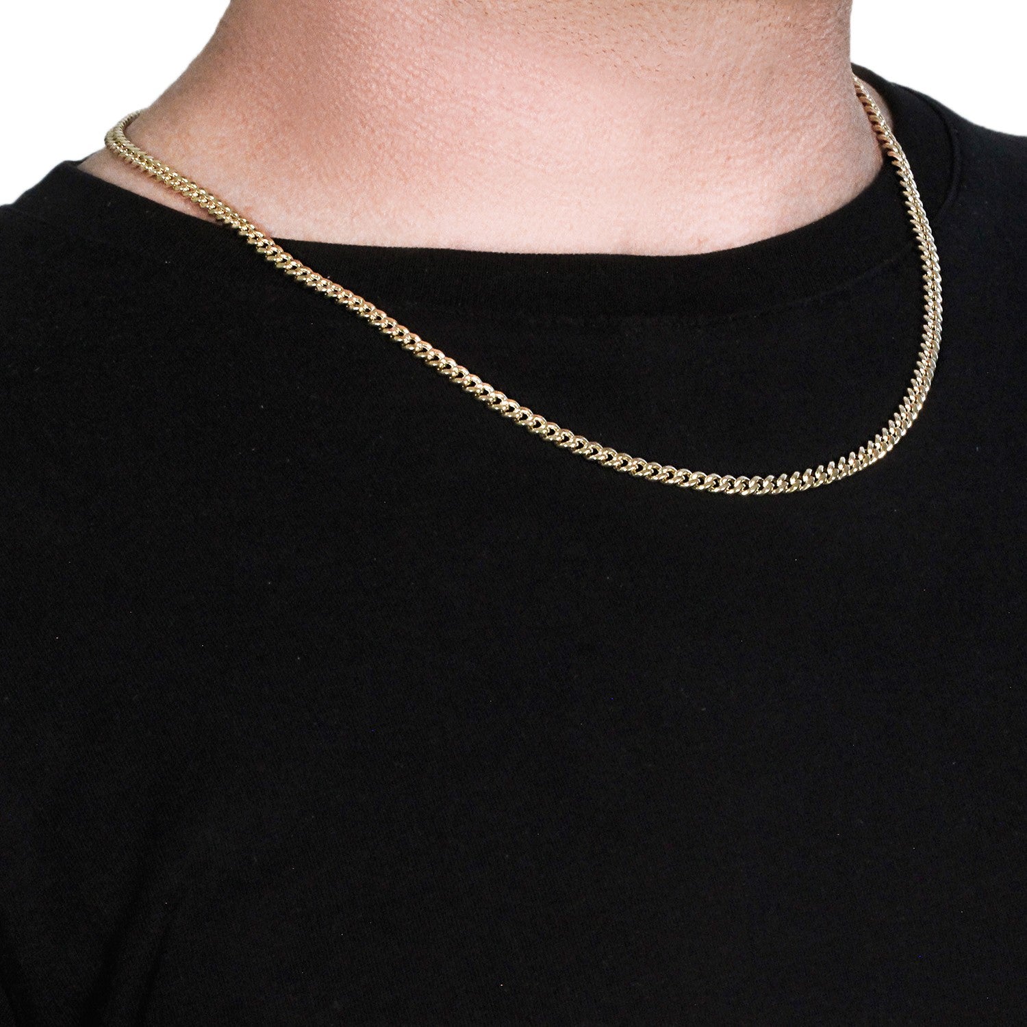 A 14k yellow gold semi-solid Miami Cuban chain, 4.5mm wide, on a person's neck.
