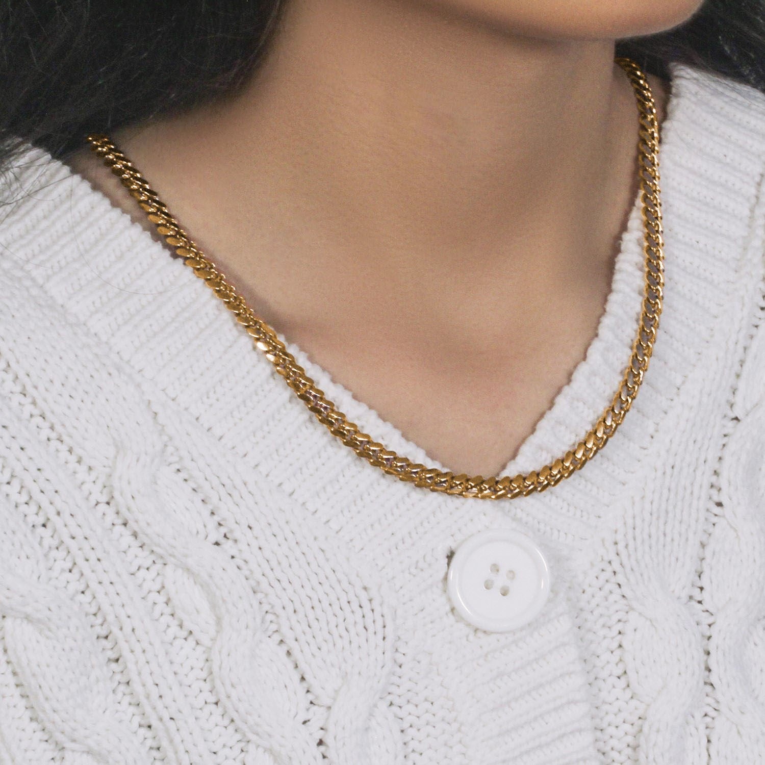 14k yellow gold classic Miami Cuban solid chain (6.10 mm) worn by a person.