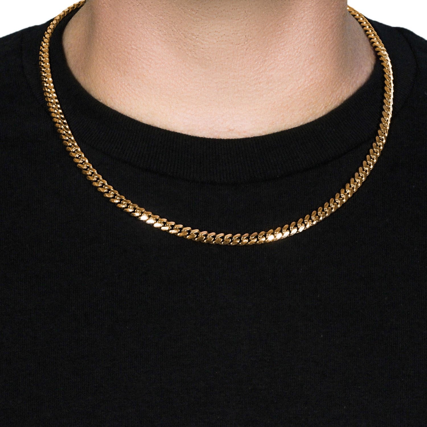 A 14k yellow gold classic Miami Cuban solid chain, 6.10 mm wide, on a person.
