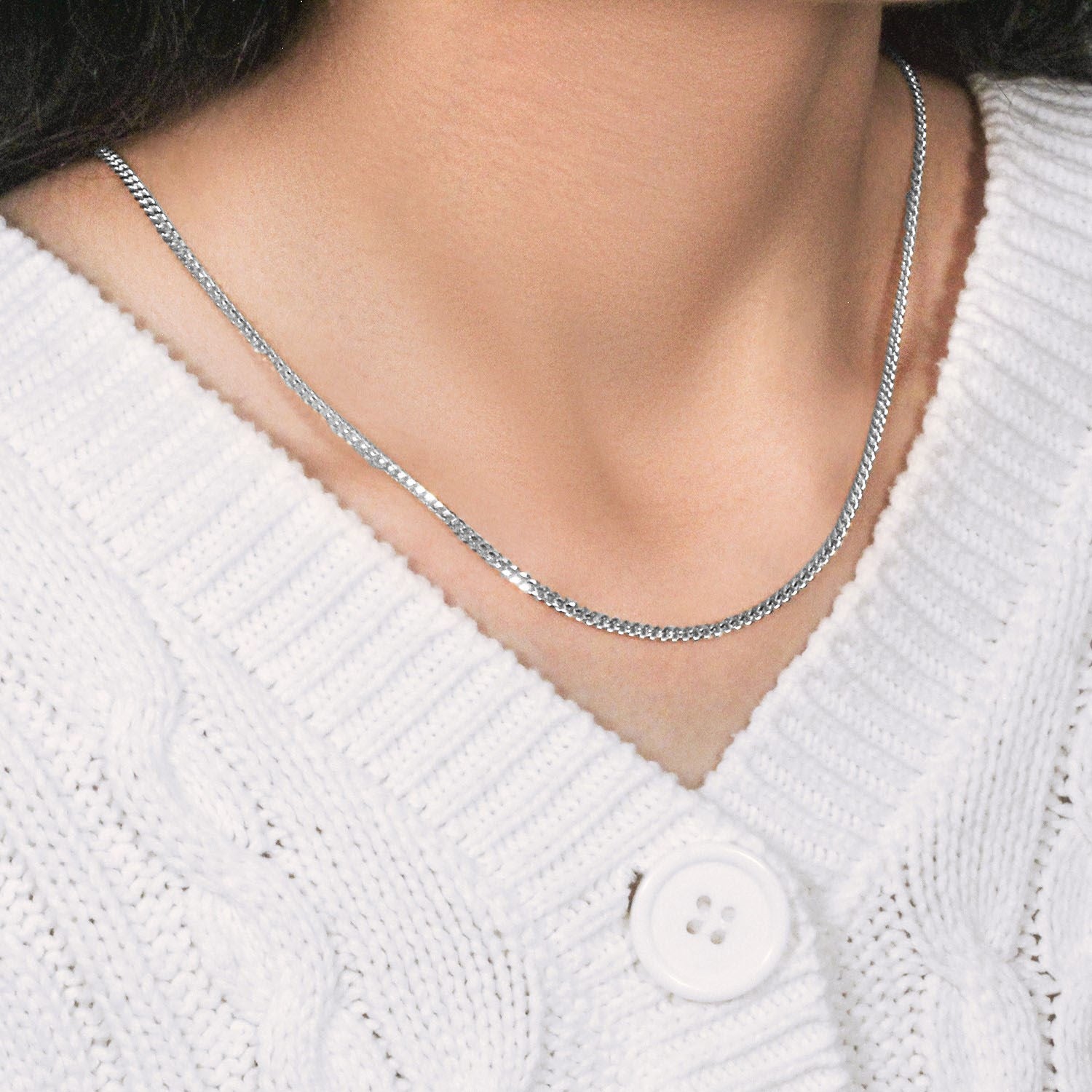 14K white gold gourmette chain (2.80 mm) on a person wearing a white sweater.