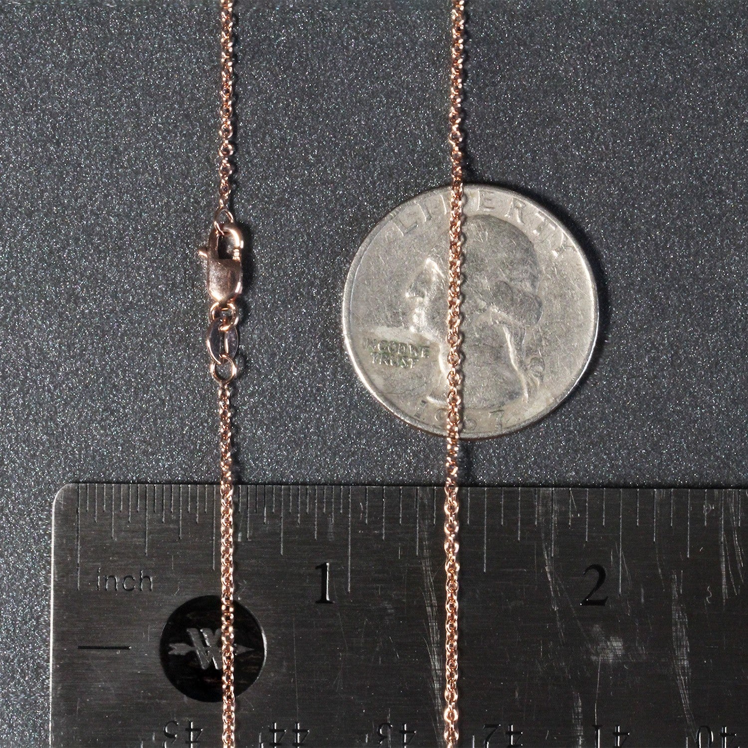 14k rose gold round cable link chain with a lobster clasp, shown with a ruler and coin.