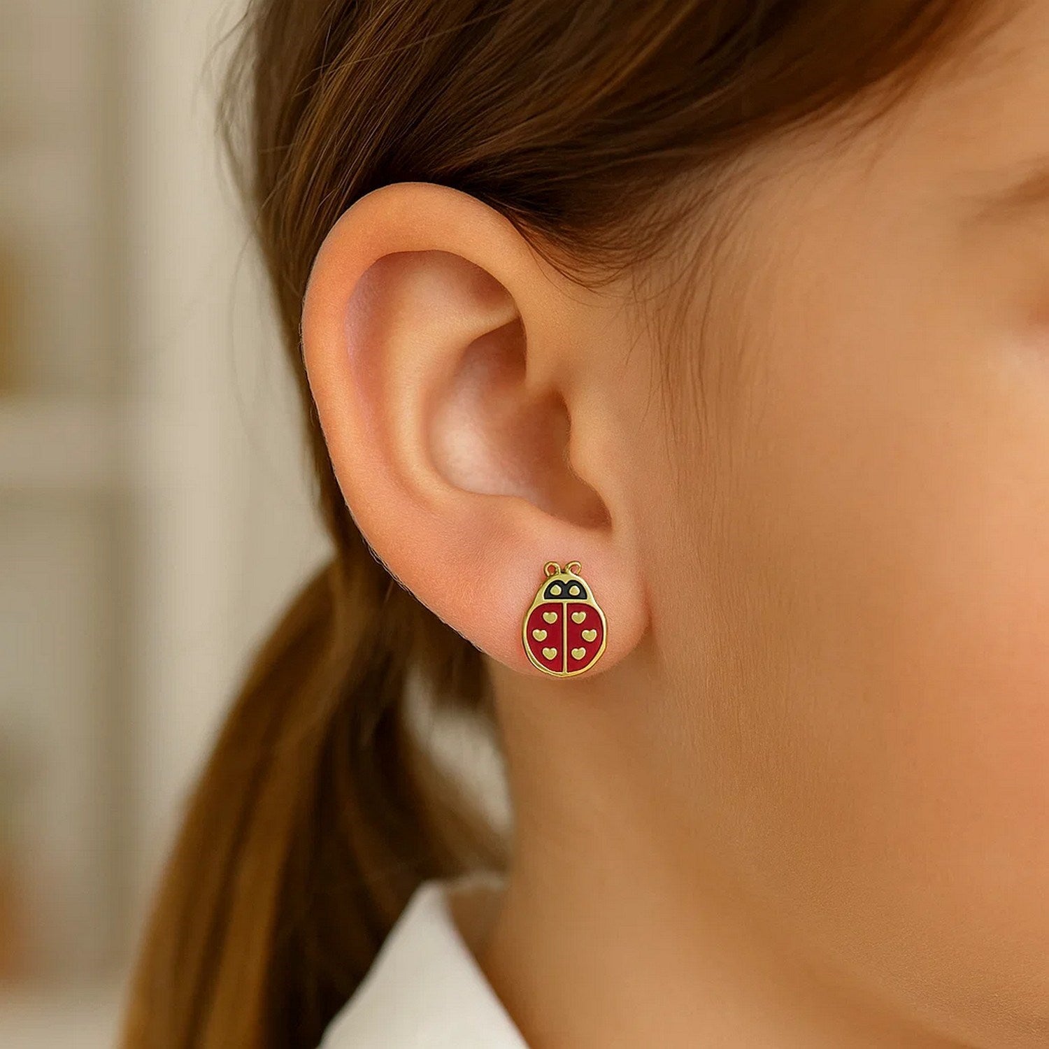14K yellow gold ladybug enamel earrings with a push back clasp.