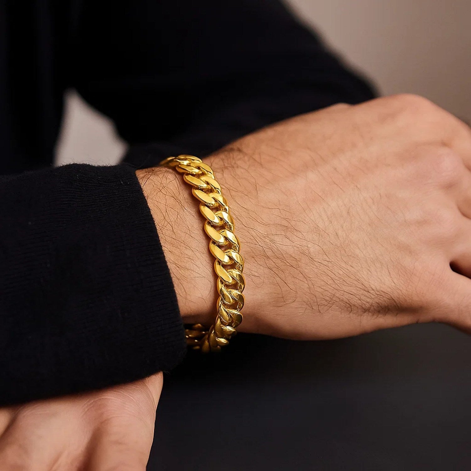 14k yellow gold classic Miami Cuban solid bracelet on a person's wrist.
