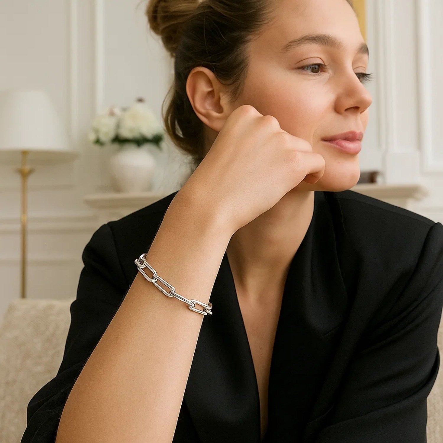14K white gold extra wide paperclip chain bracelet on a woman's wrist.