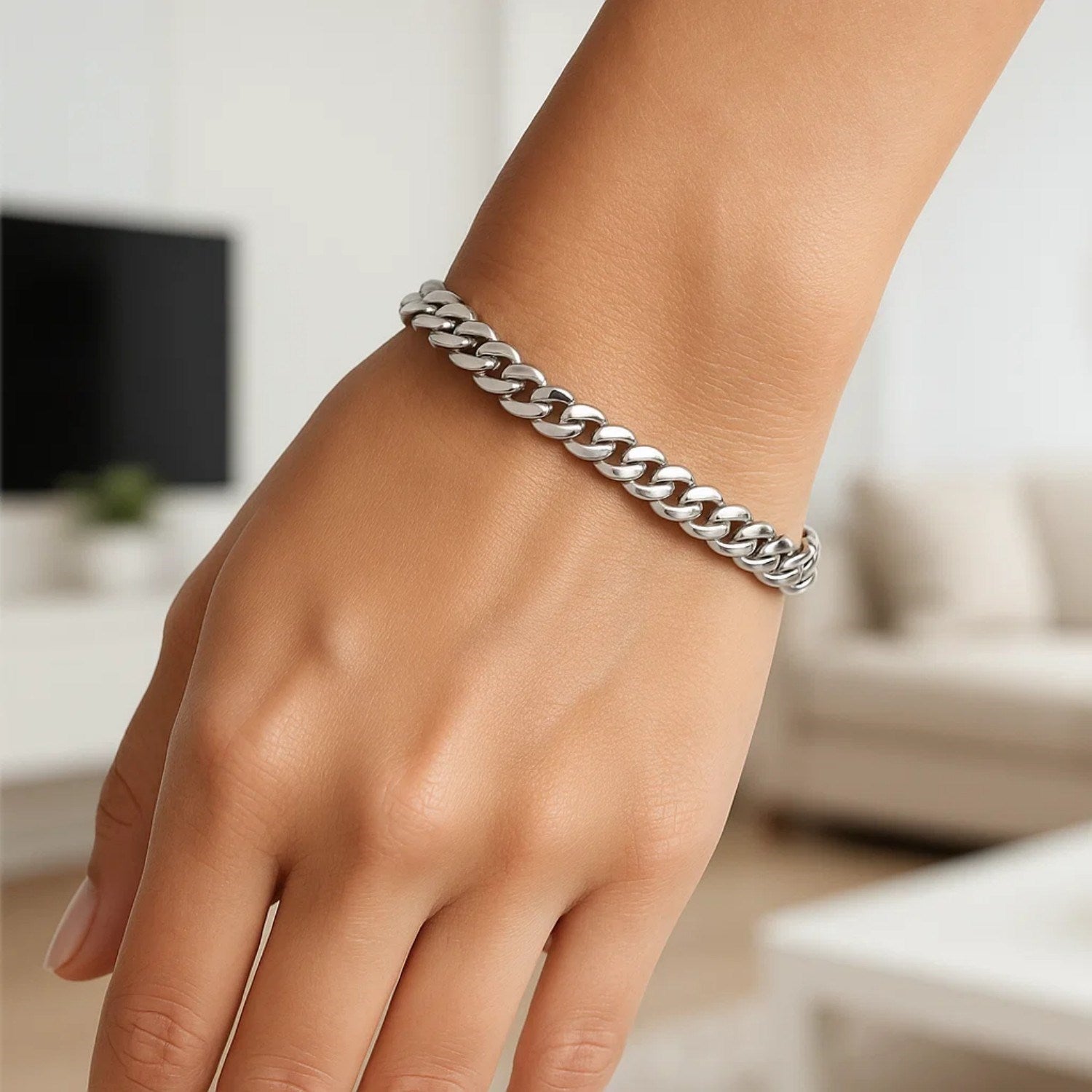 14K white gold Cuban link bracelet on a person's wrist.