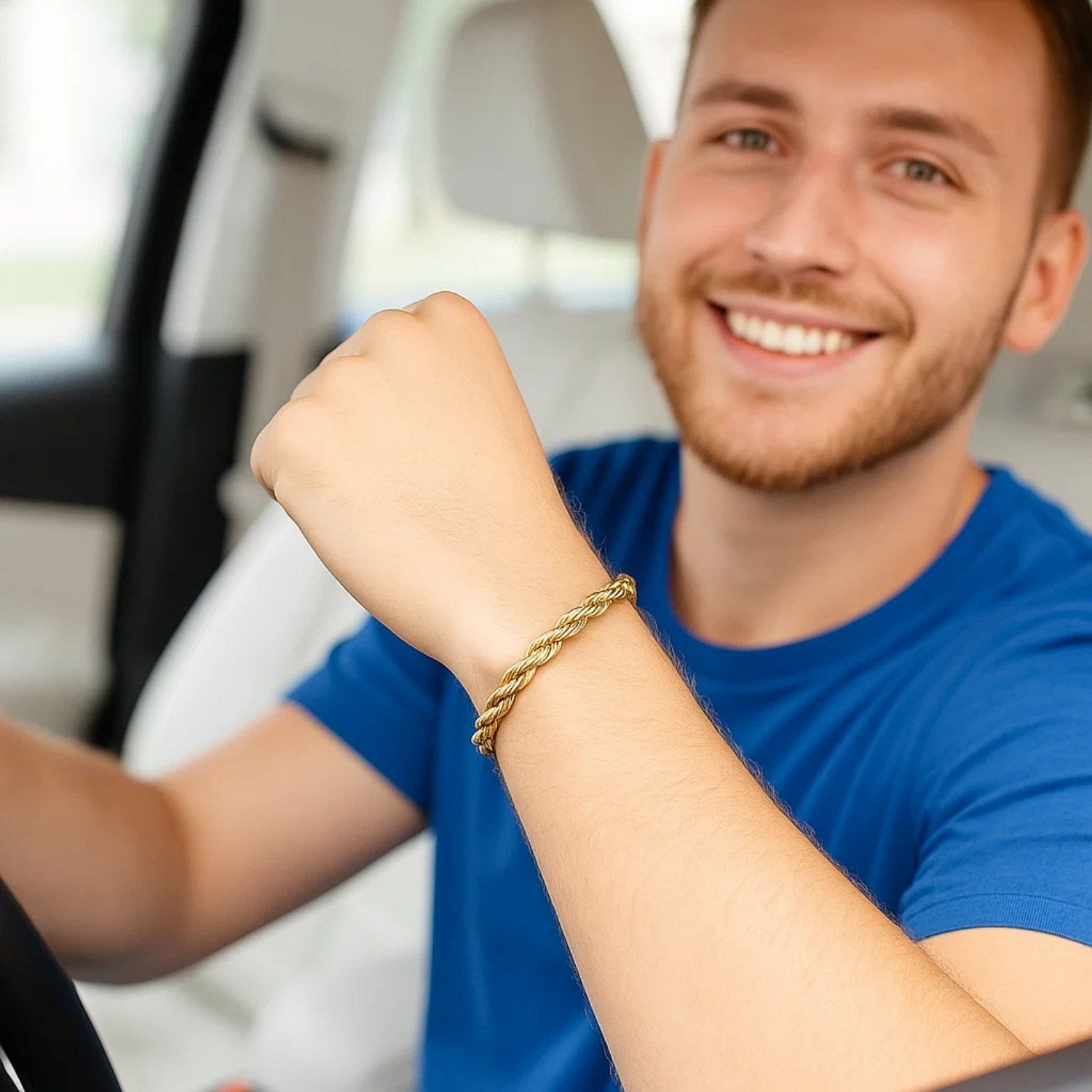 A man in a blue shirt wears a 10k yellow gold solid diamond cut rope bracelet.