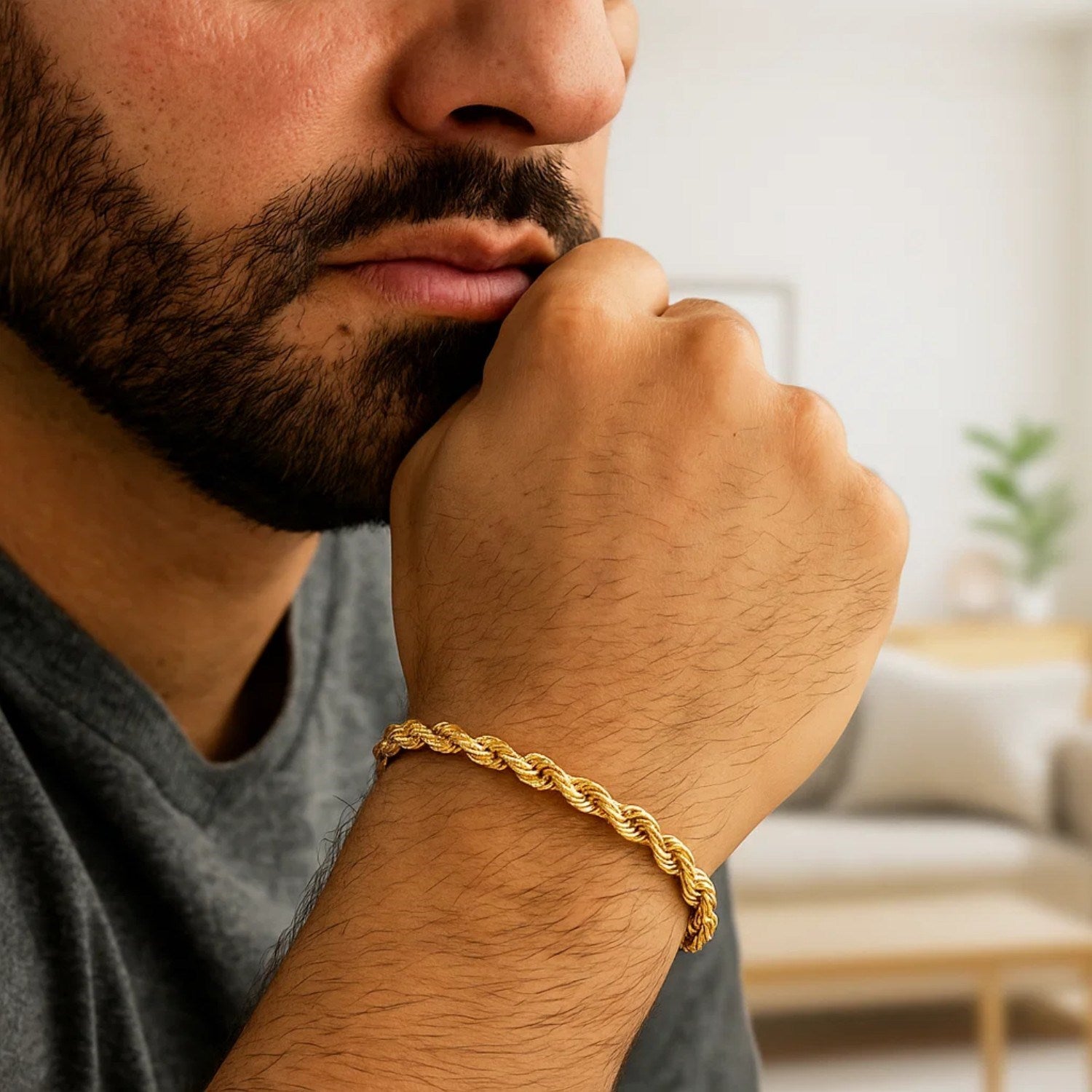 A man wears a 10k yellow gold solid diamond cut rope bracelet.