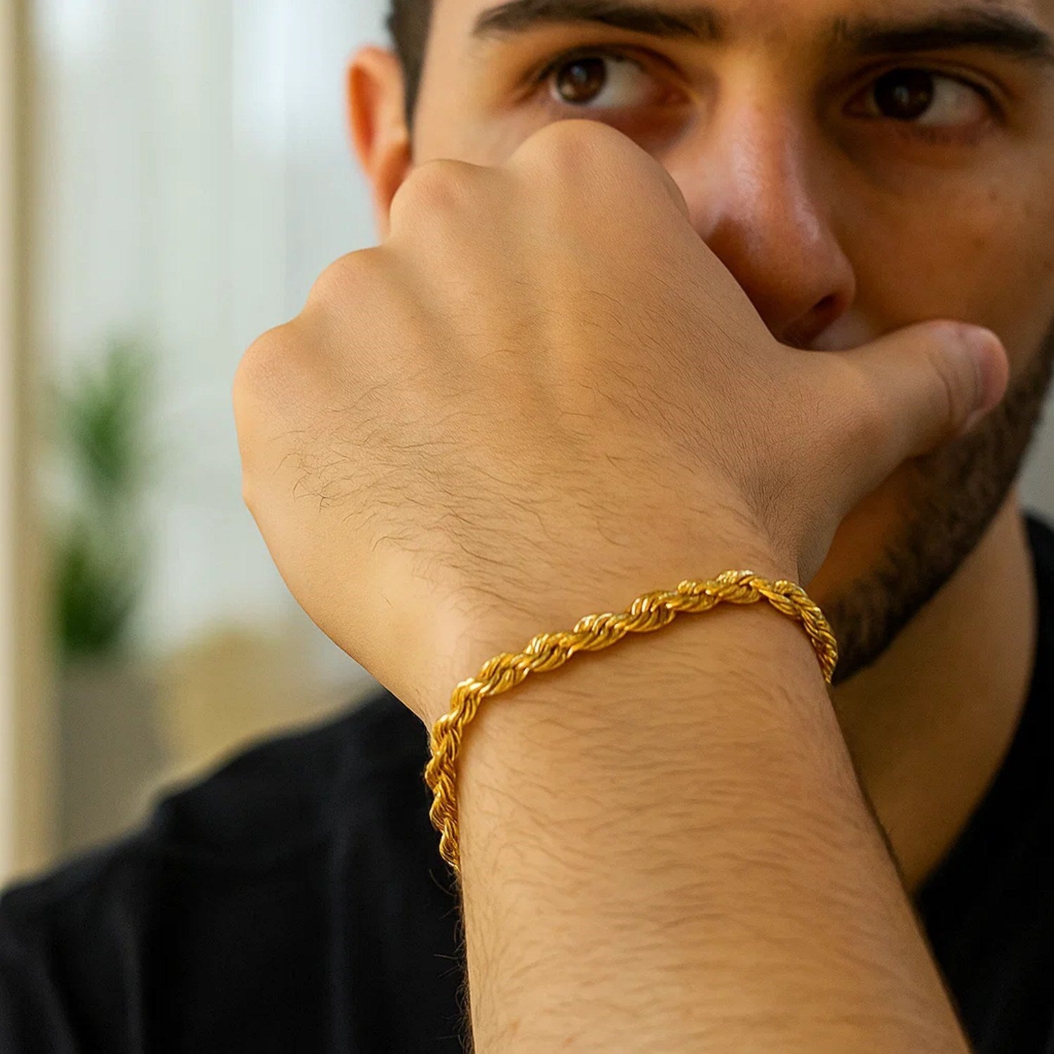 10k yellow gold solid diamond cut rope bracelet on a man's wrist.