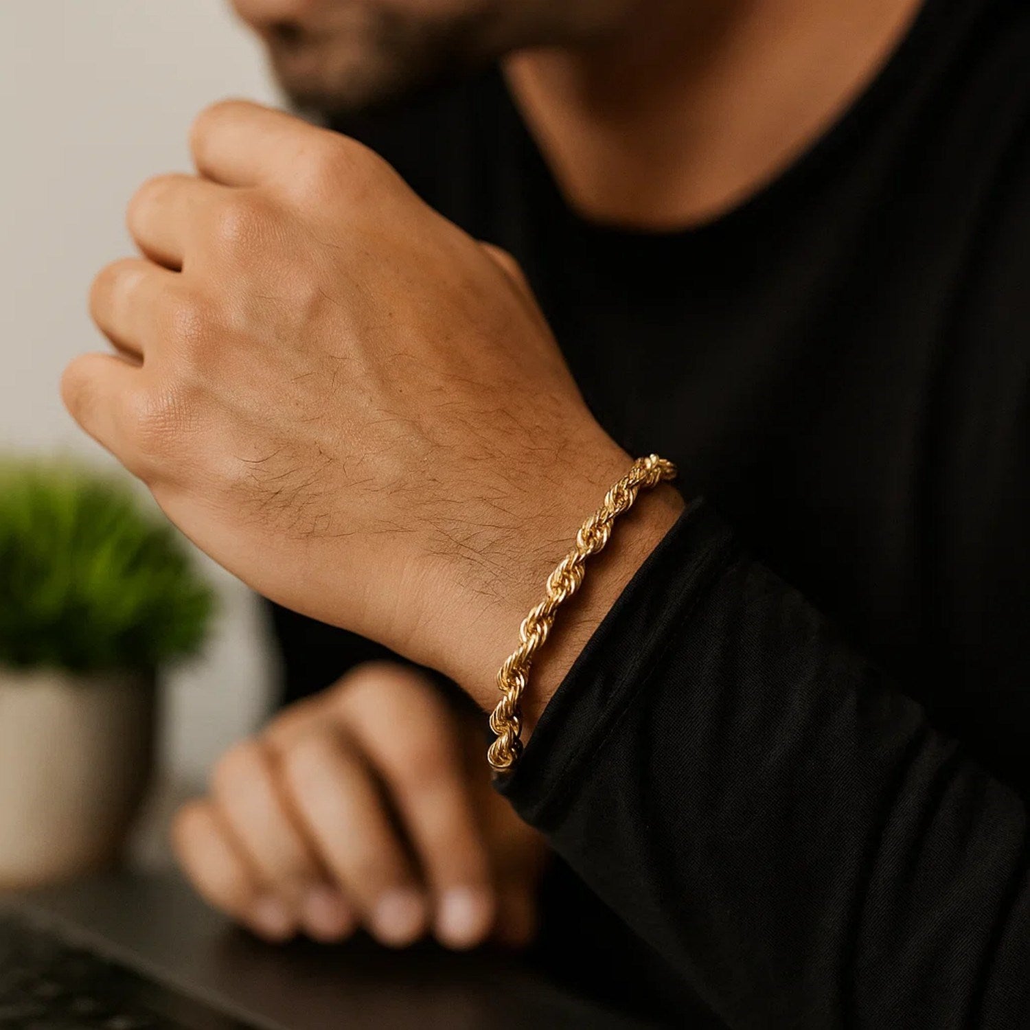10k yellow gold solid diamond cut rope bracelet on a person's wrist.