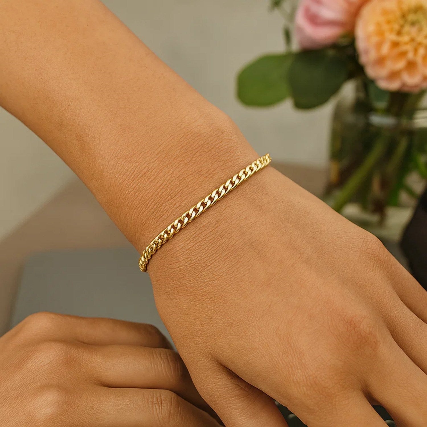 14k yellow gold classic Miami Cuban solid bracelet on a person's wrist.