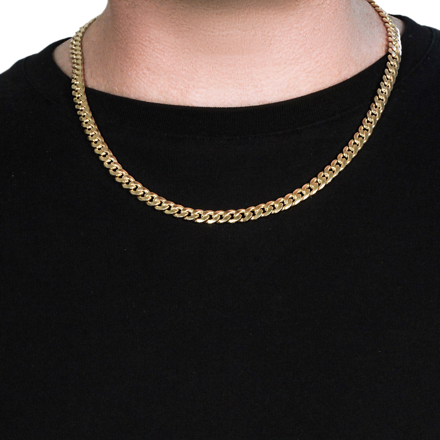 A 14k yellow gold Miami Cuban semi-solid chain, 7.00 mm wide, on a person's neck.