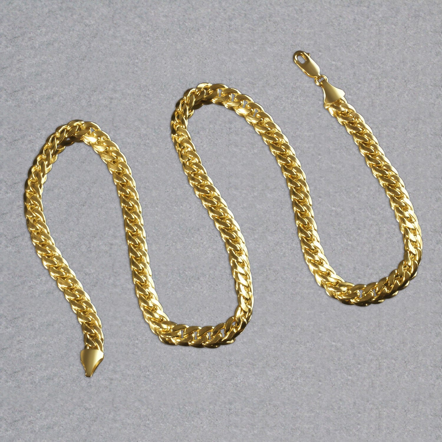 A 14k yellow gold Miami Cuban semi-solid chain with a lobster clasp.