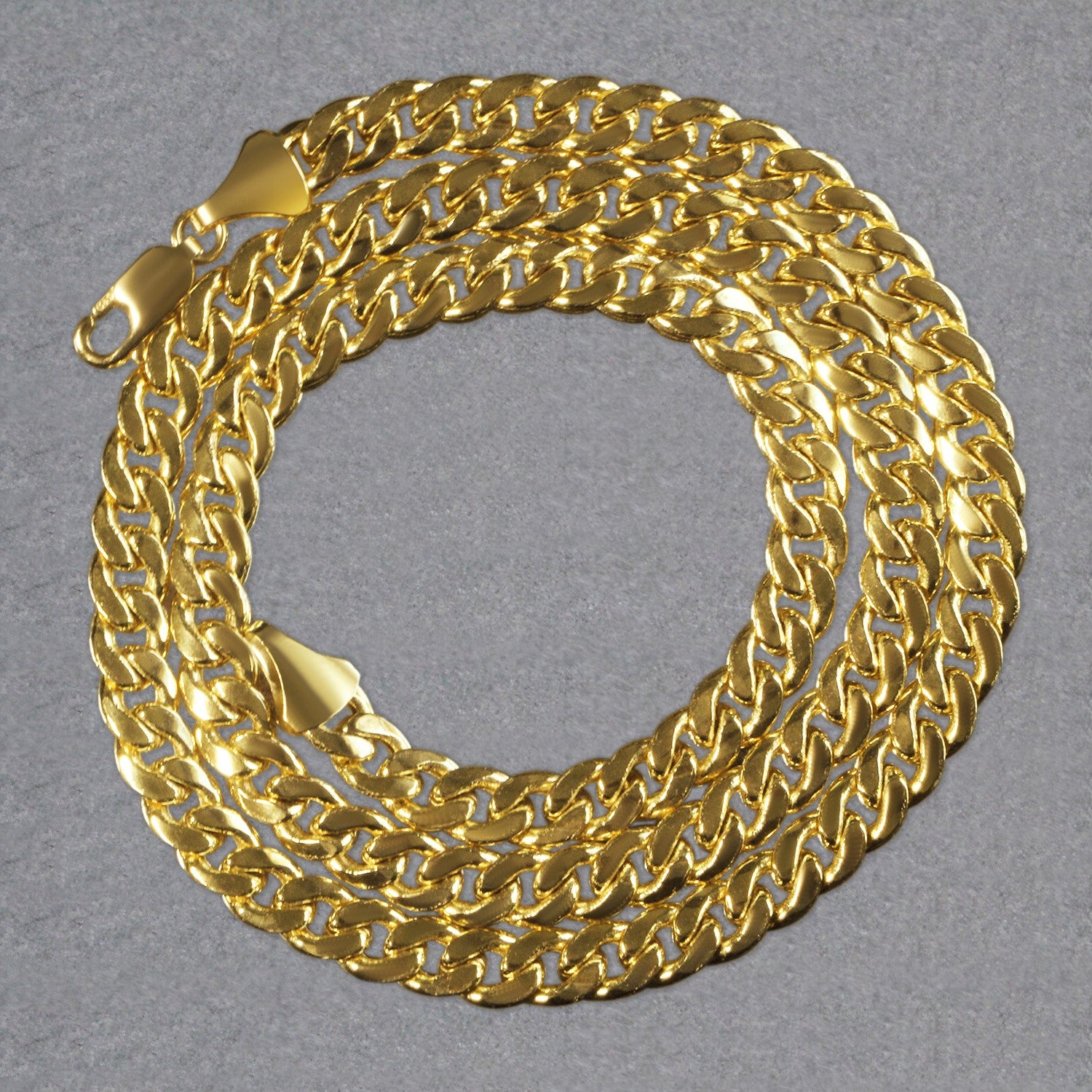 A 14k yellow gold Miami Cuban semi-solid chain with a lobster clasp.