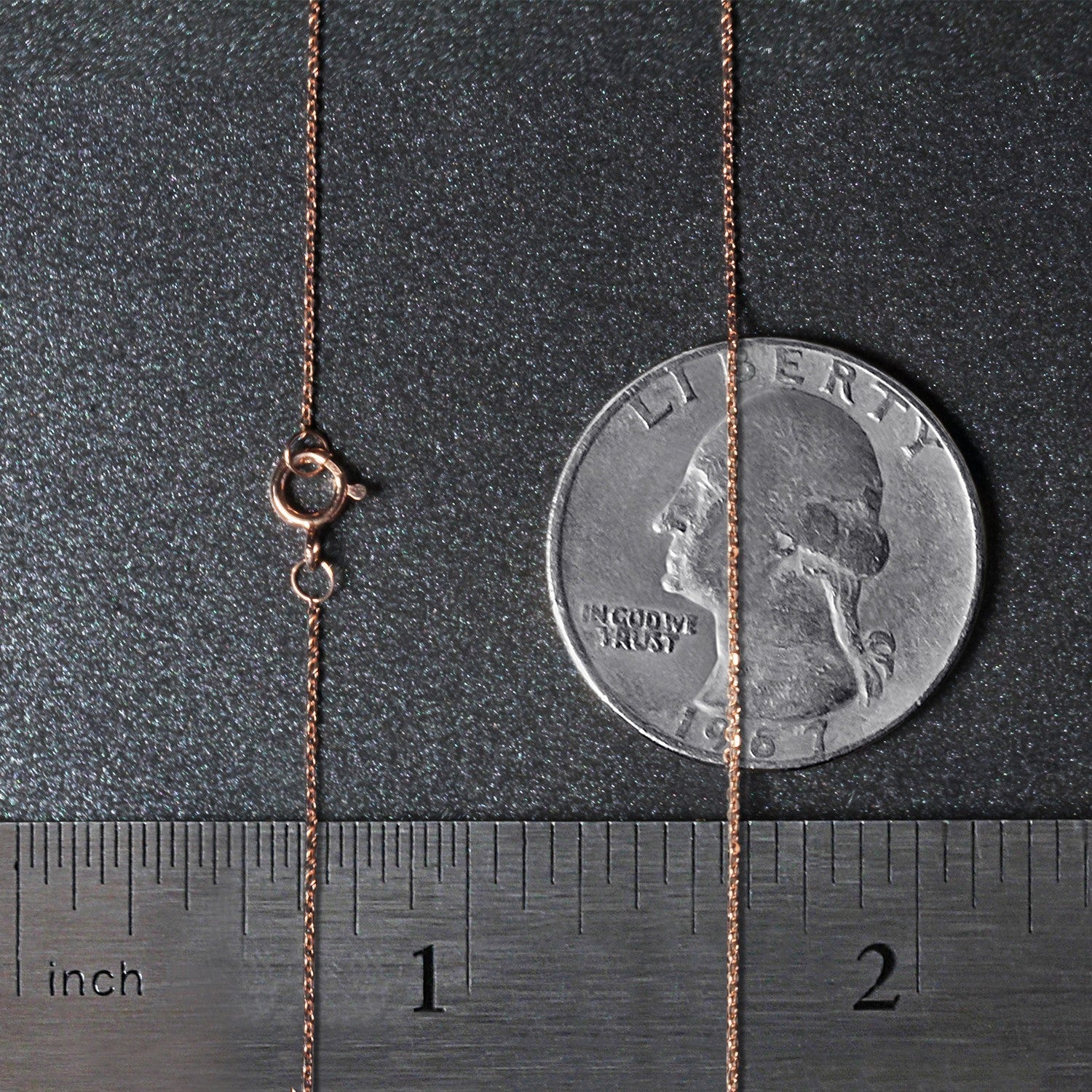 A 14k rose gold diamond cut cable link chain with a spring ring clasp.