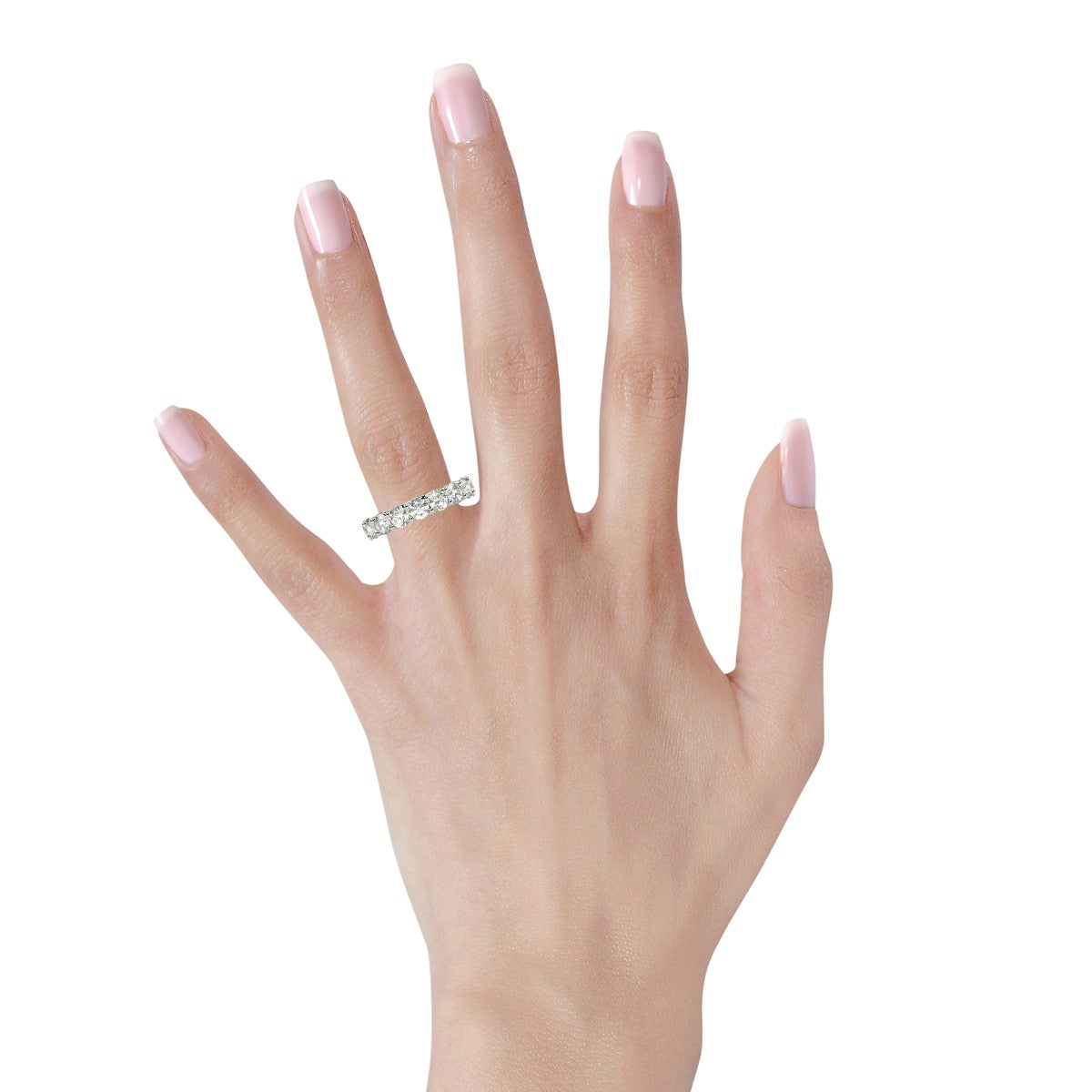 Round cut lab grown diamond eternity ring in 14k white gold on a hand.