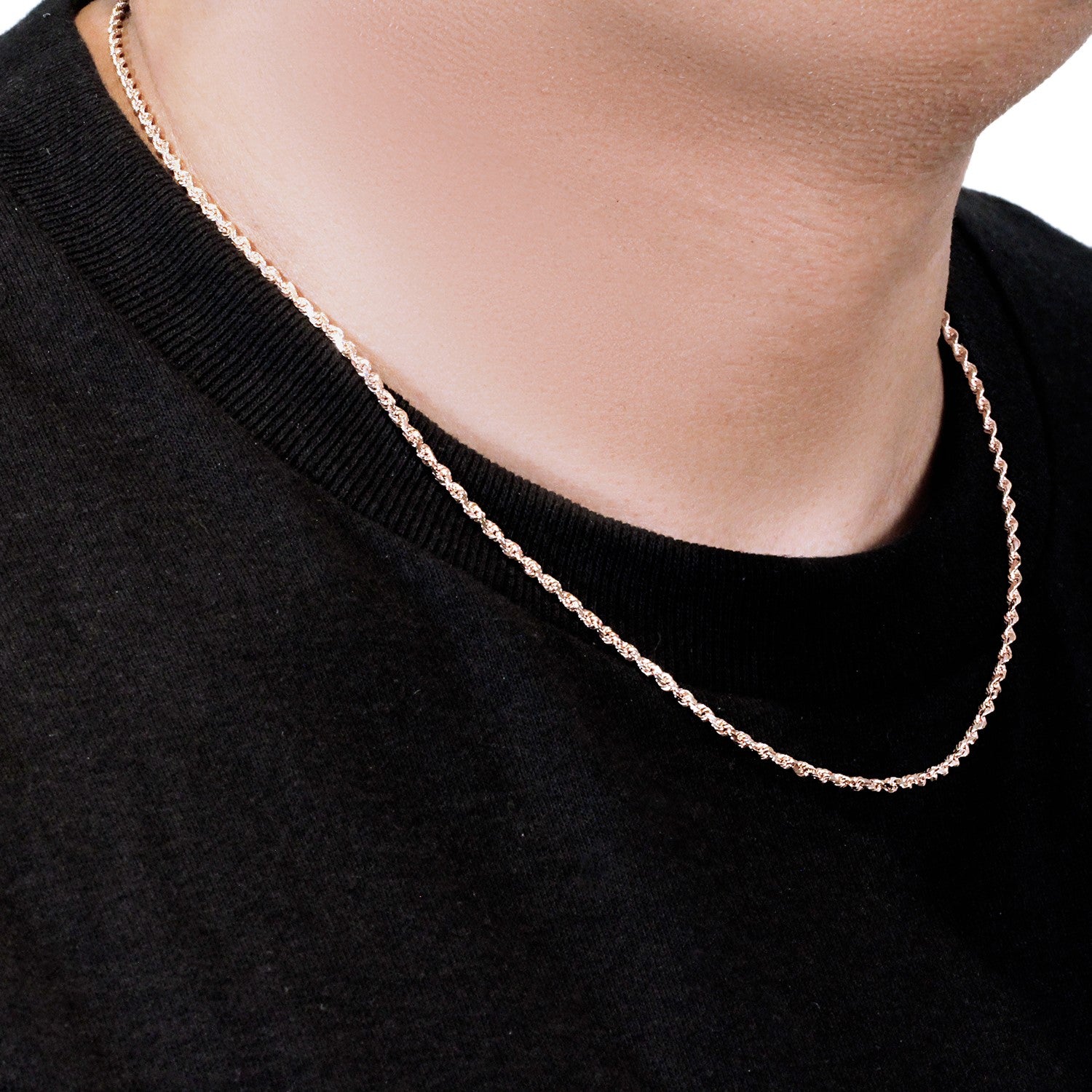 A 14k rose gold solid diamond cut rope chain is worn around a person's neck.