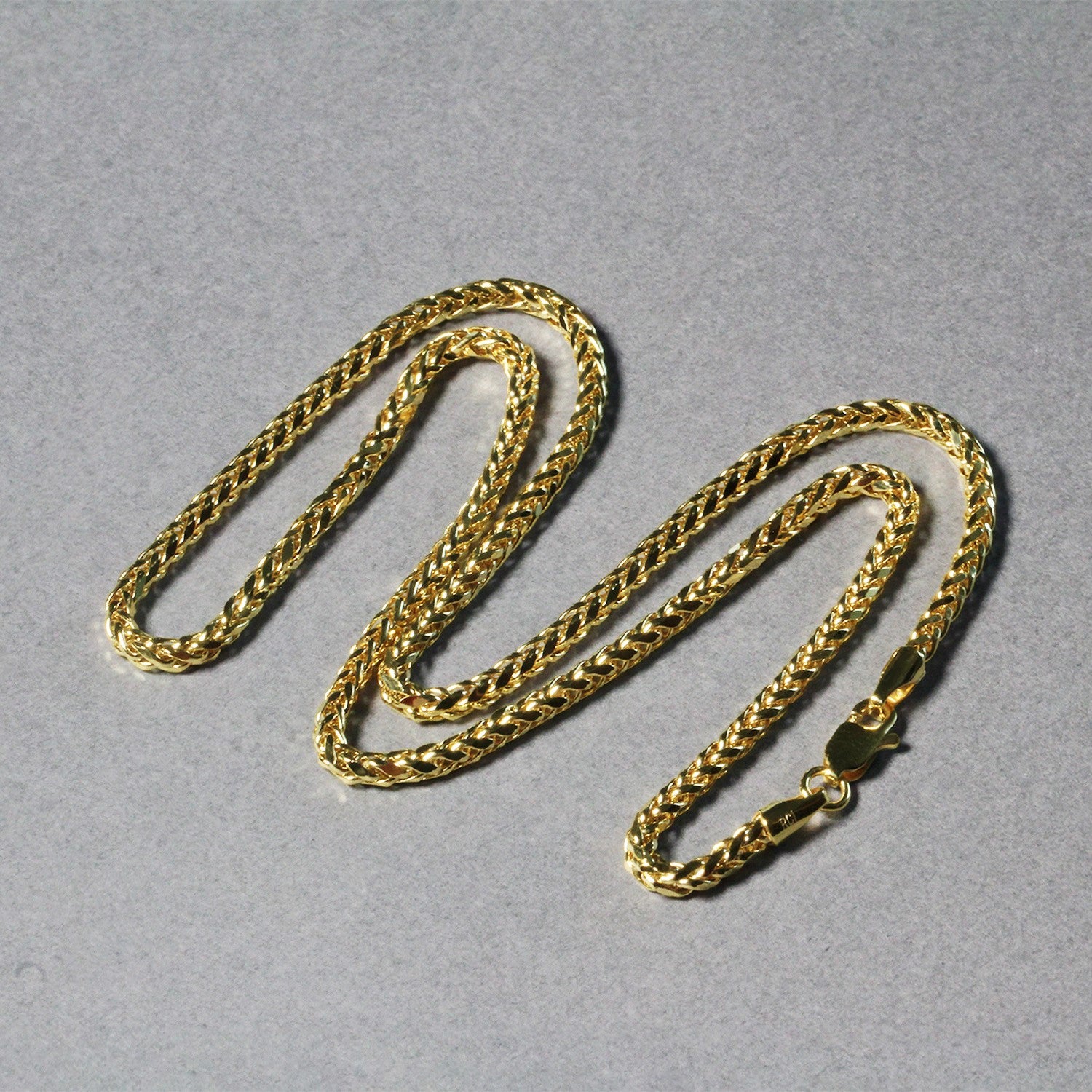 A 14k yellow gold lite diamond cut round Franco chain with a lobster clasp.