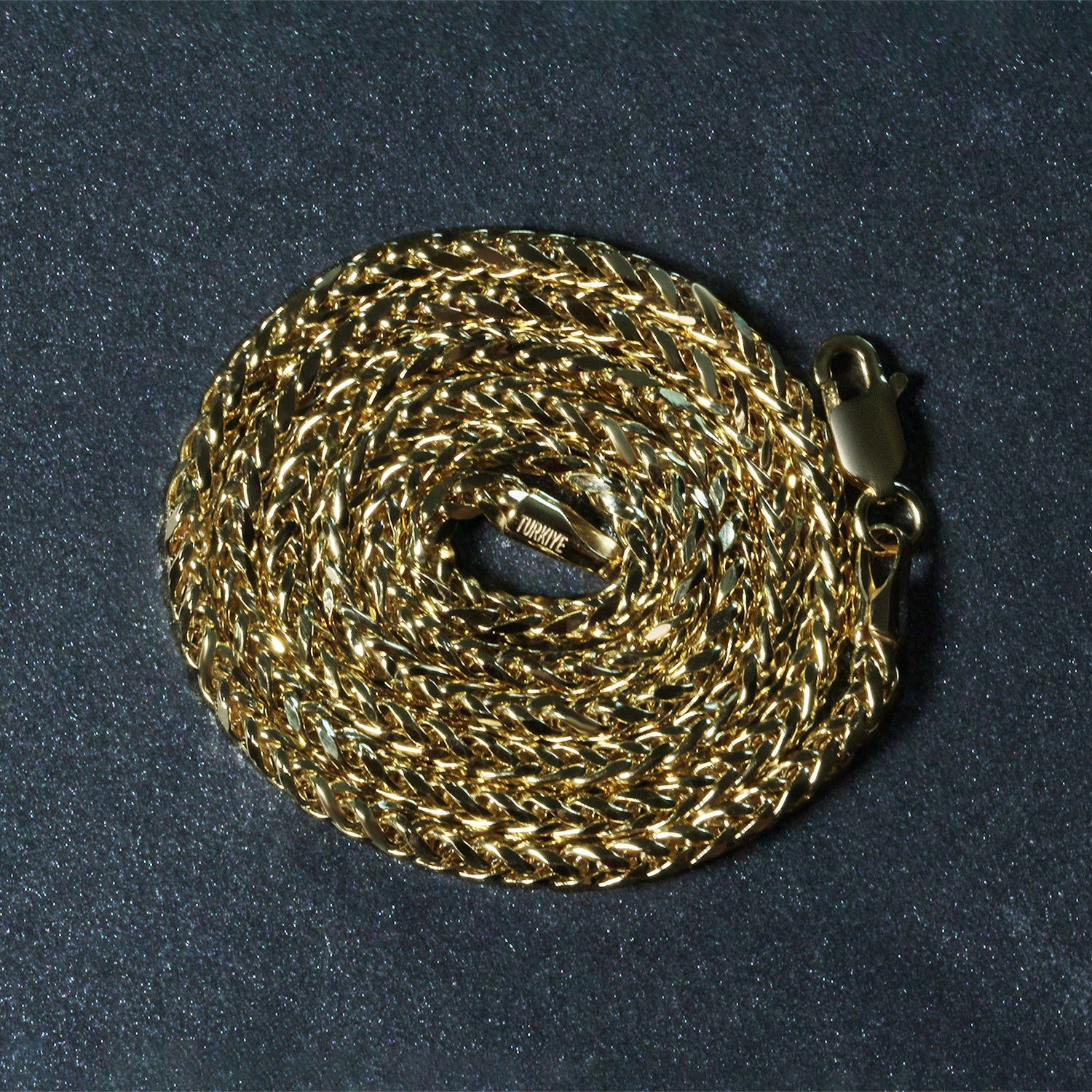 A 14k yellow gold lite diamond cut round Franco chain with a lobster clasp.