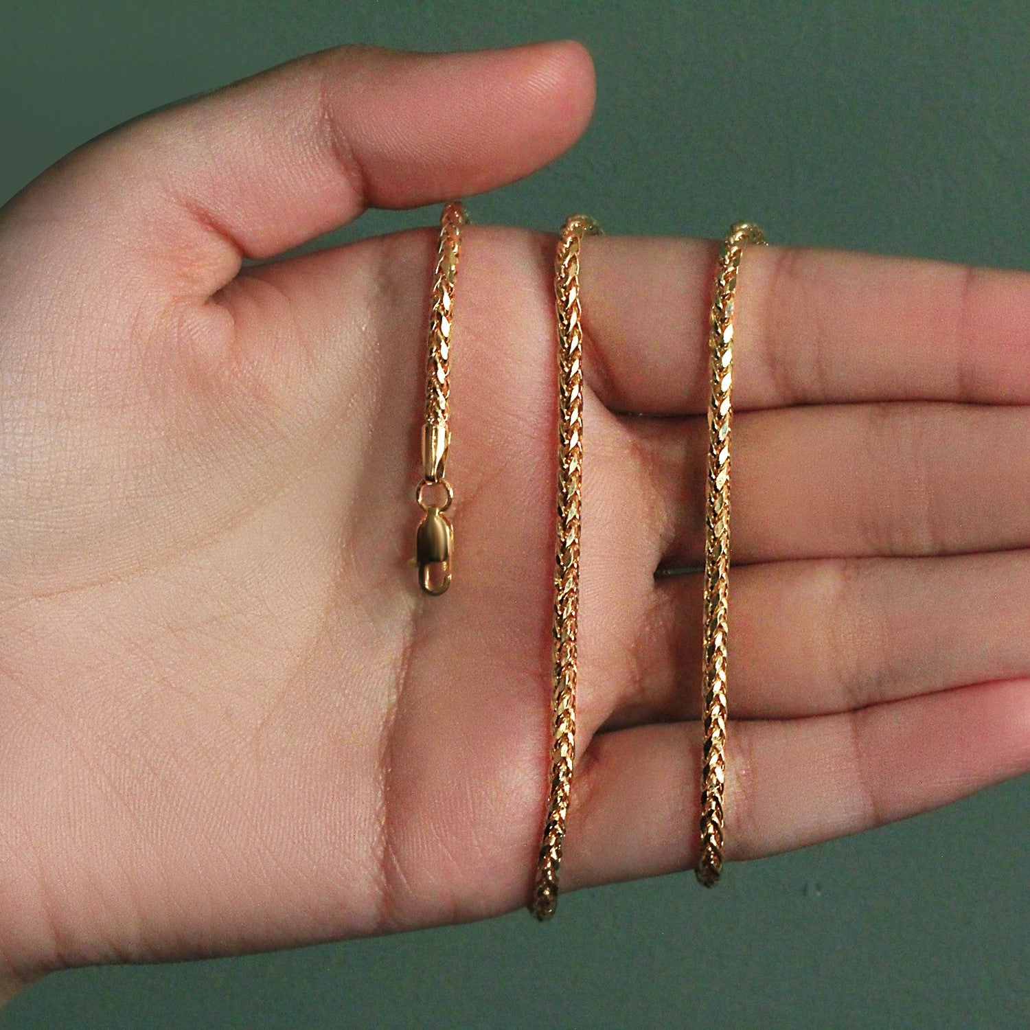 14k yellow gold lite diamond cut round franco chain held in a hand.