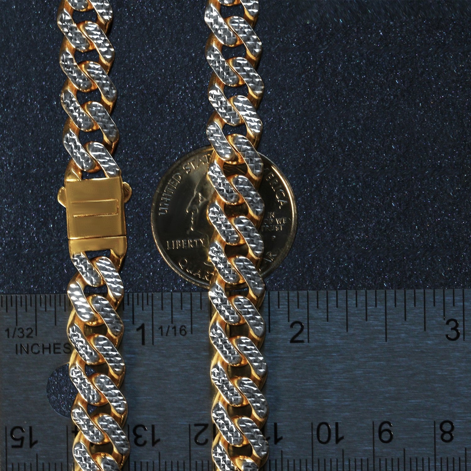 A two-tone gold Miami Cuban chain necklace with a box clasp is shown next to a ruler.