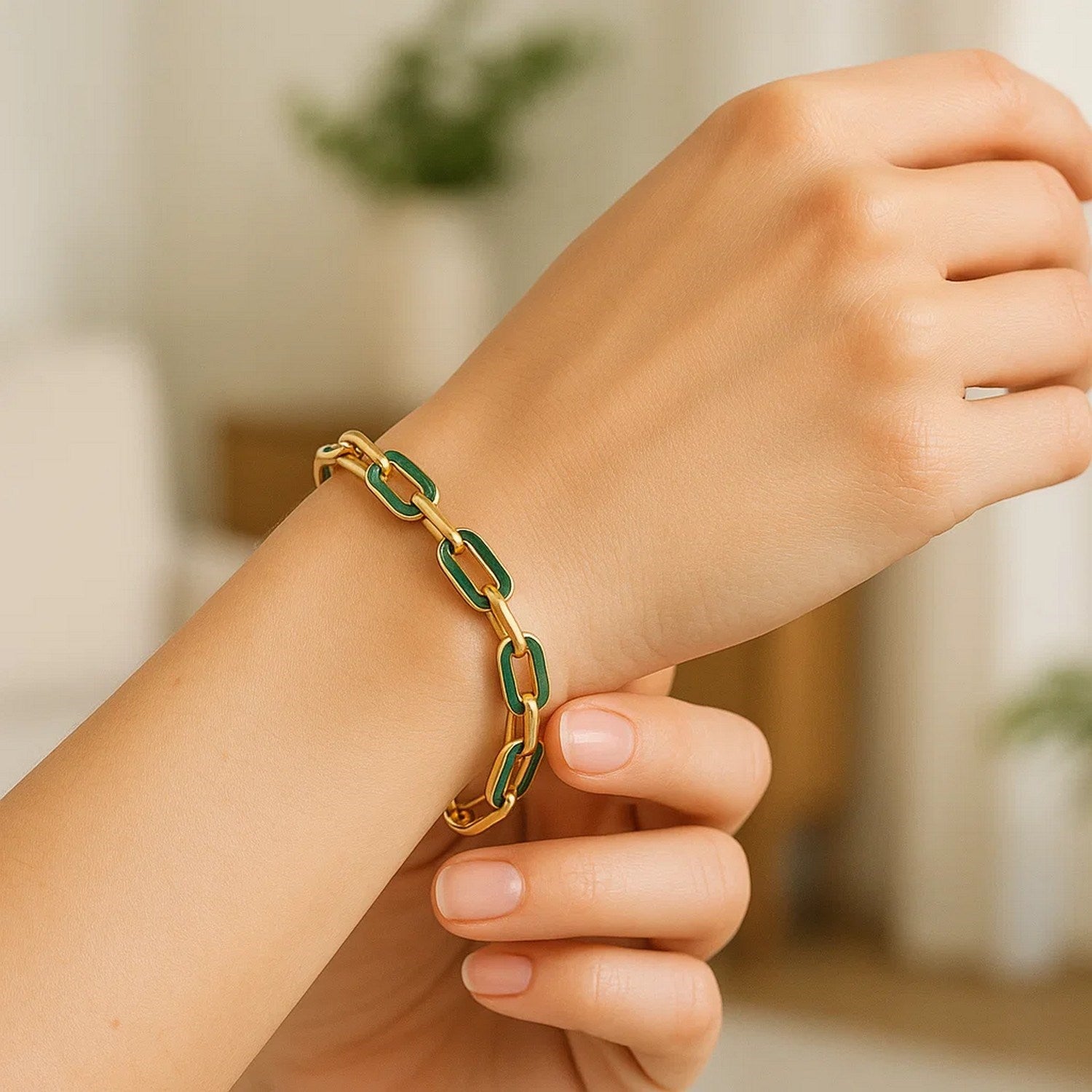 14k yellow gold paperclip link bracelet with green malachite on a person's wrist.