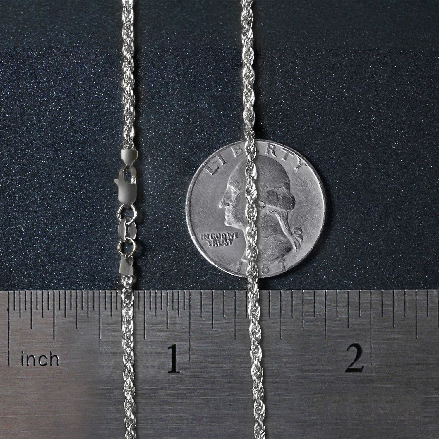 A 14k white gold light rope chain with a lobster clasp, shown with a quarter for scale.