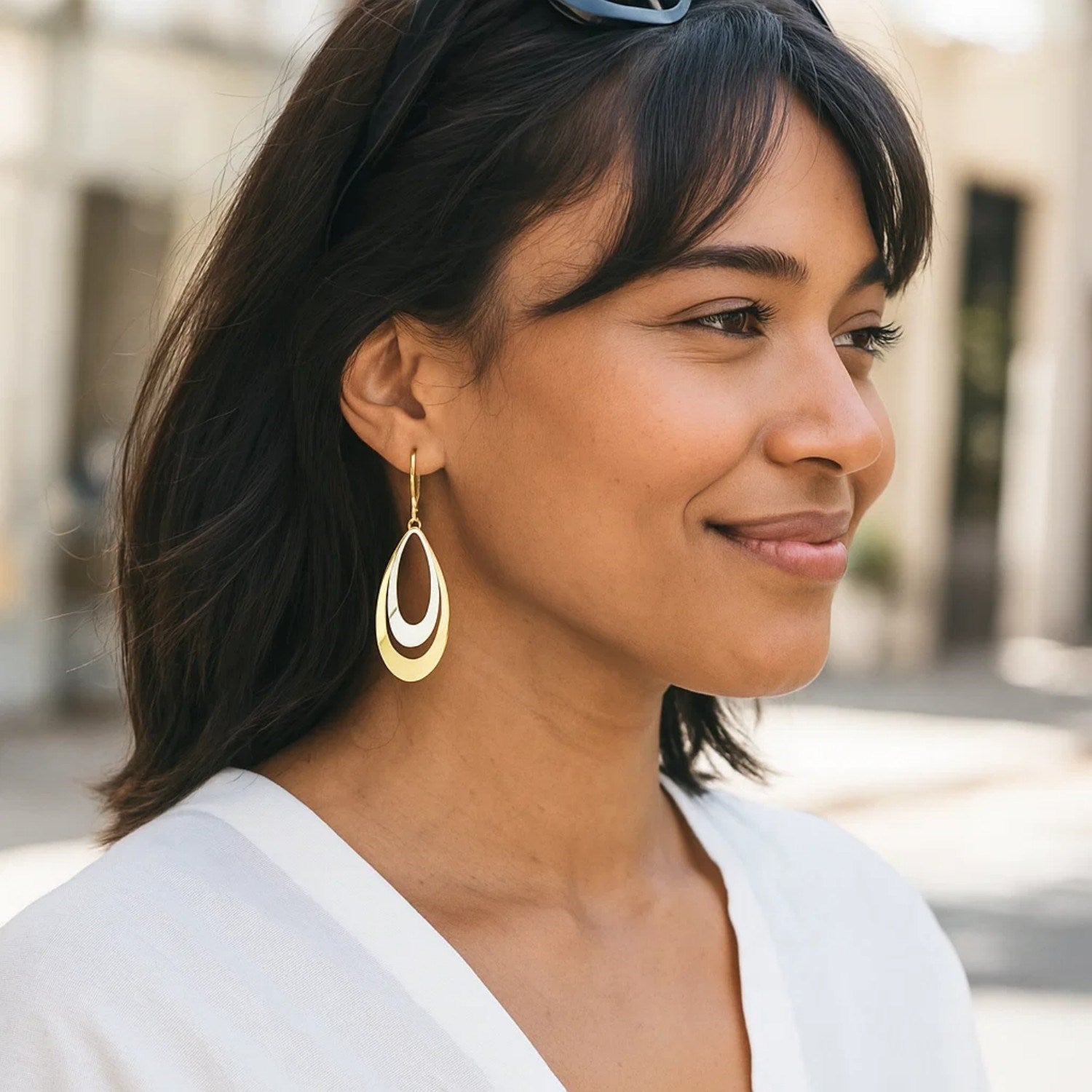 14k two-tone gold graduated open double teardrop earrings with lever backs.