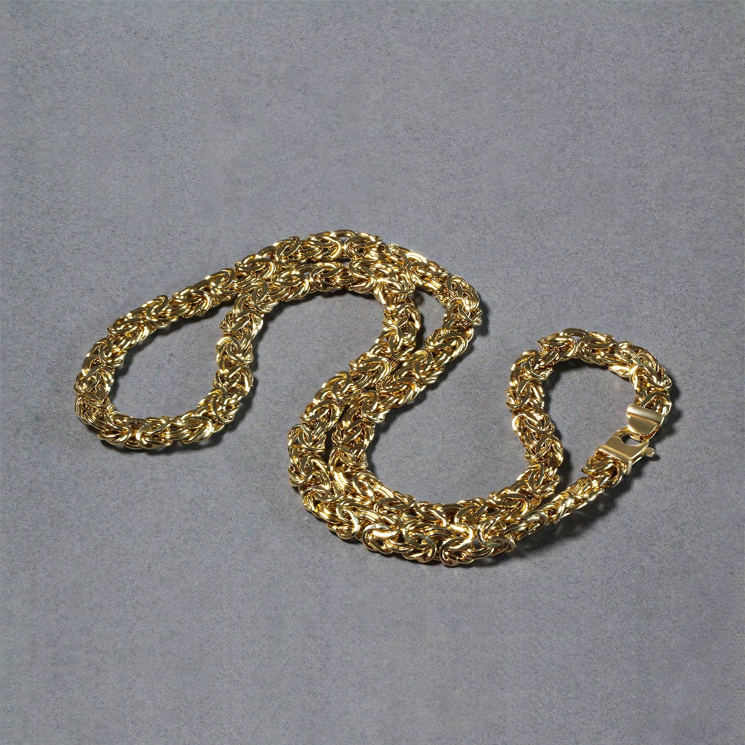 A 14k yellow gold Byzantine chain necklace with a lobster clasp.