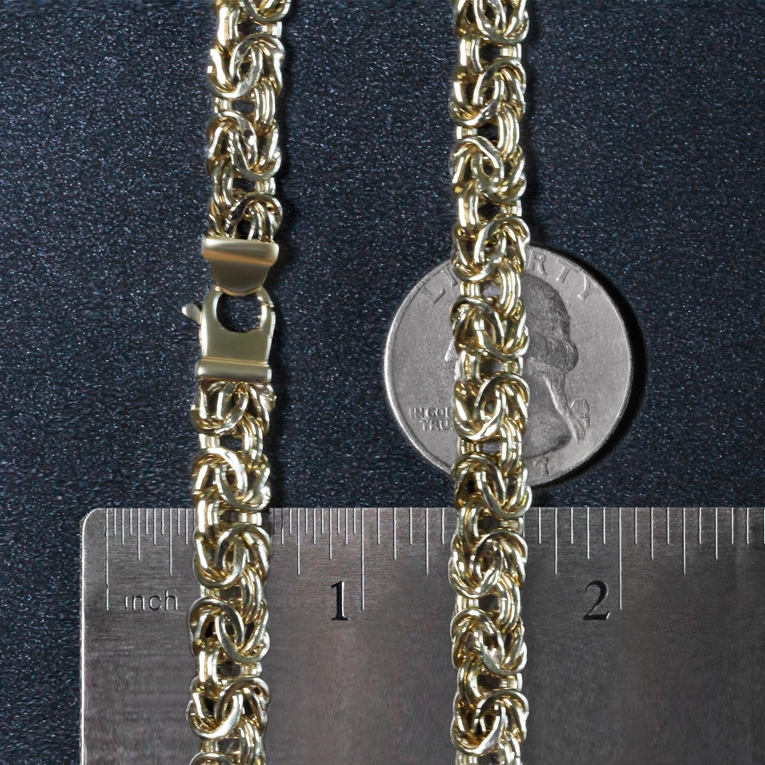 14k yellow gold Byzantine chain necklace with a lobster clasp, shown with a ruler and coin for scale.