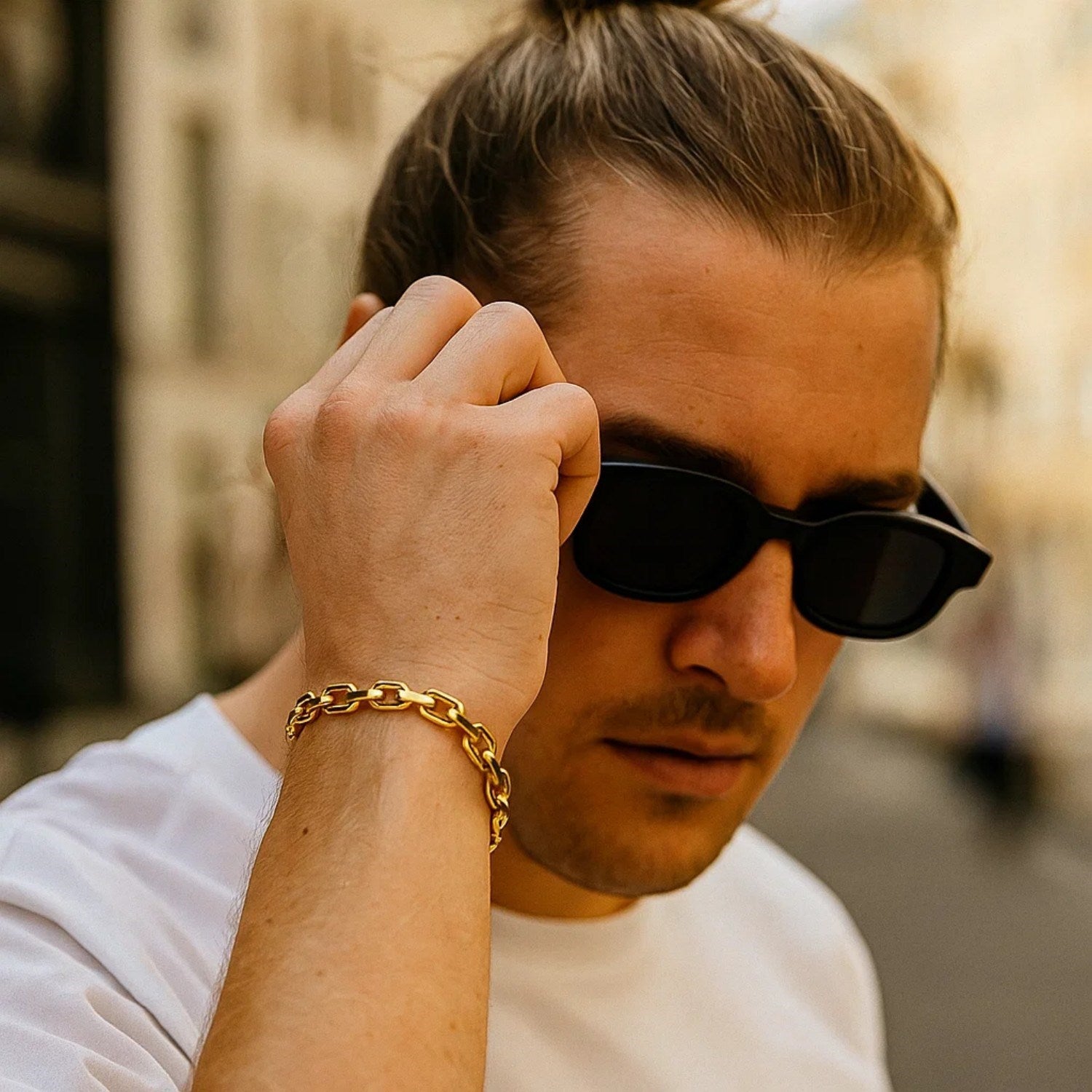14k yellow gold French cable chain bracelet on a man's wrist.