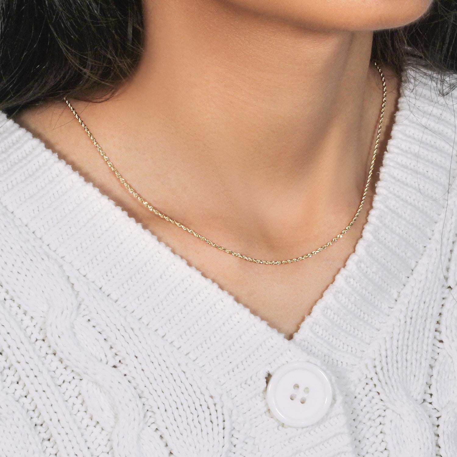 10k yellow gold solid diamond cut rope chain on a person wearing a white sweater.