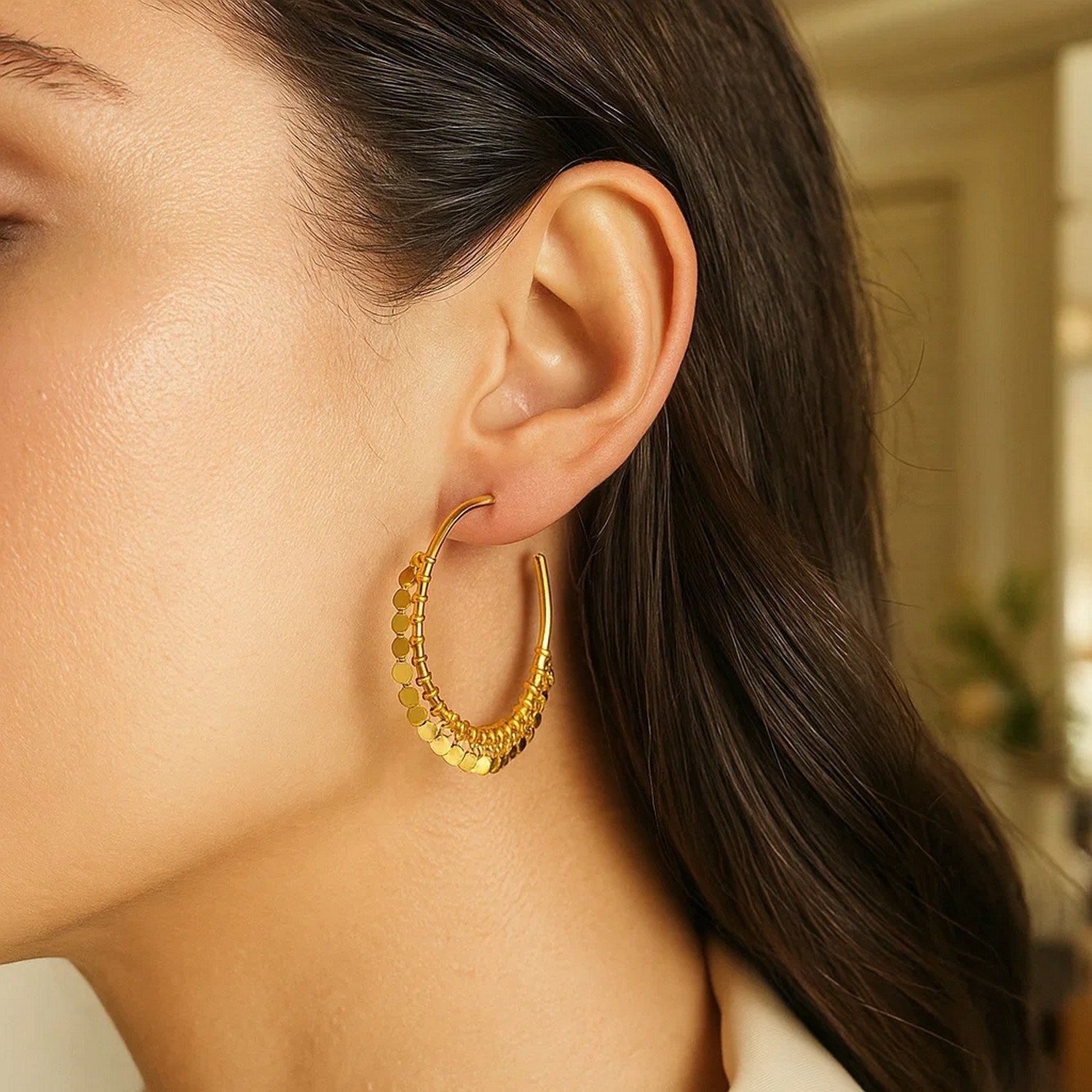 14k yellow gold hoop earrings with dangling sequins.