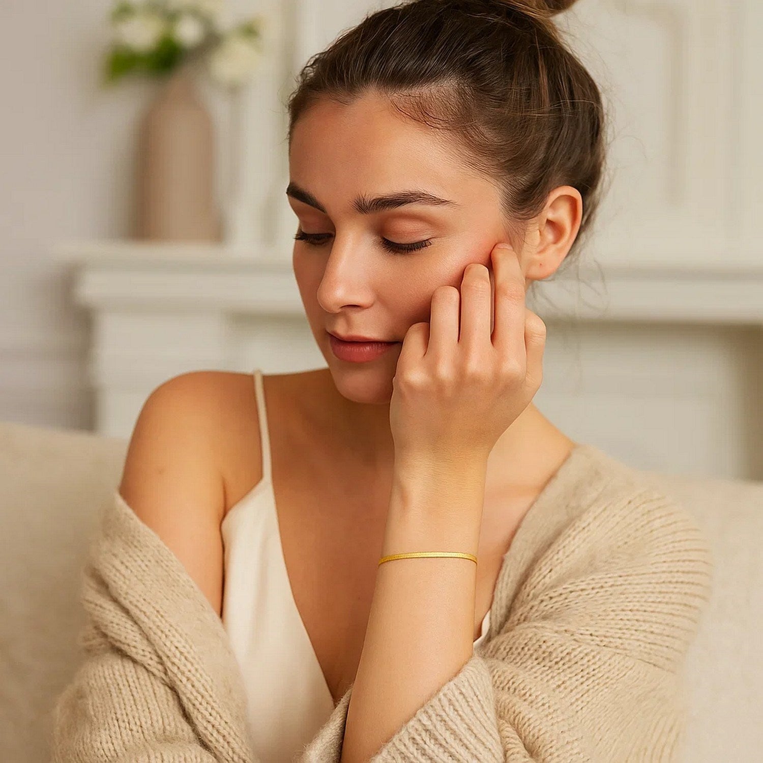 14k yellow gold super flex herringbone bracelet on a woman's wrist.