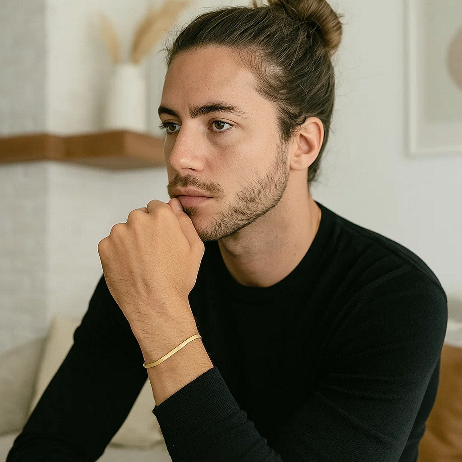 A man wearing a 14k yellow gold super flex herringbone bracelet.