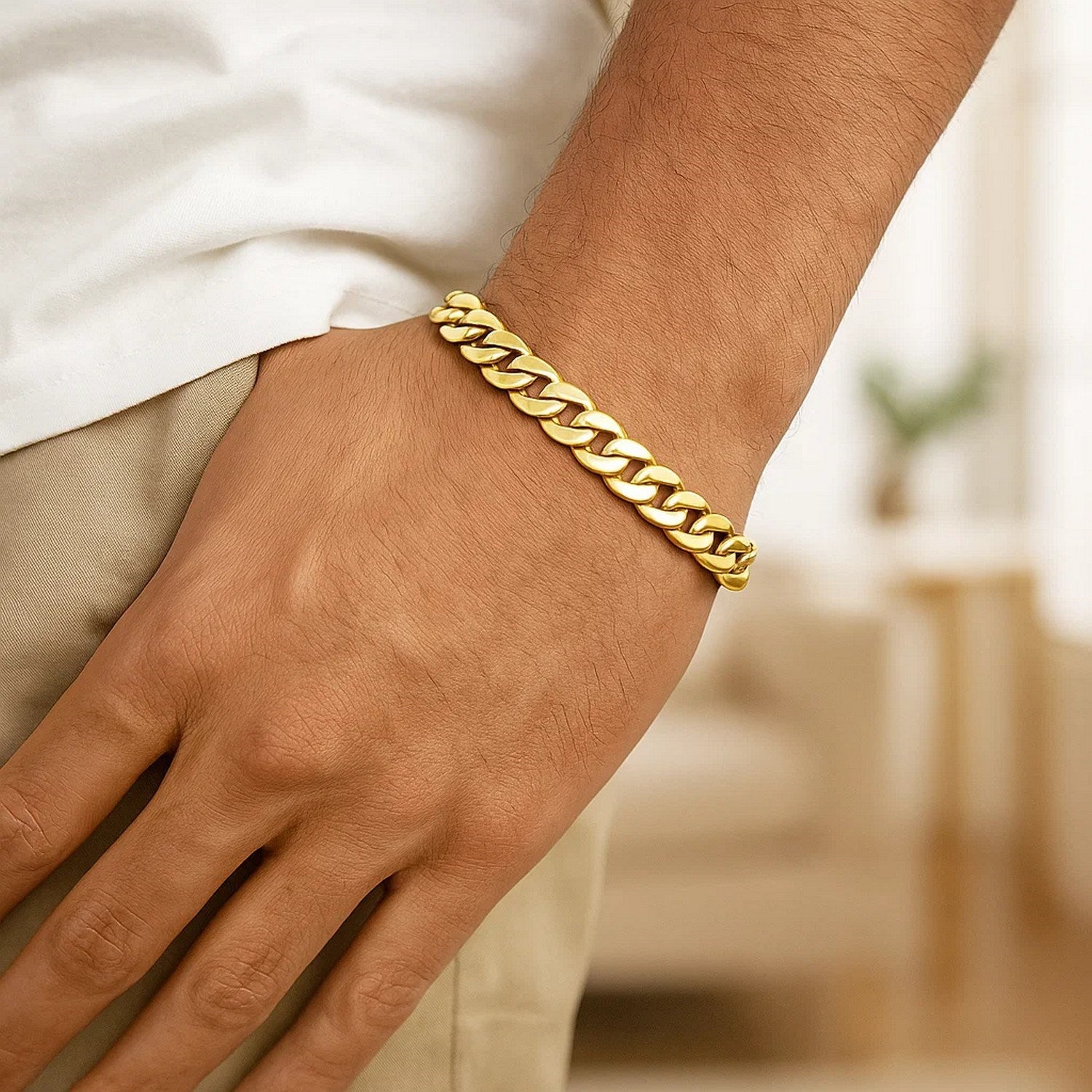 10k yellow gold light Miami Cuban bracelet on a person's wrist.