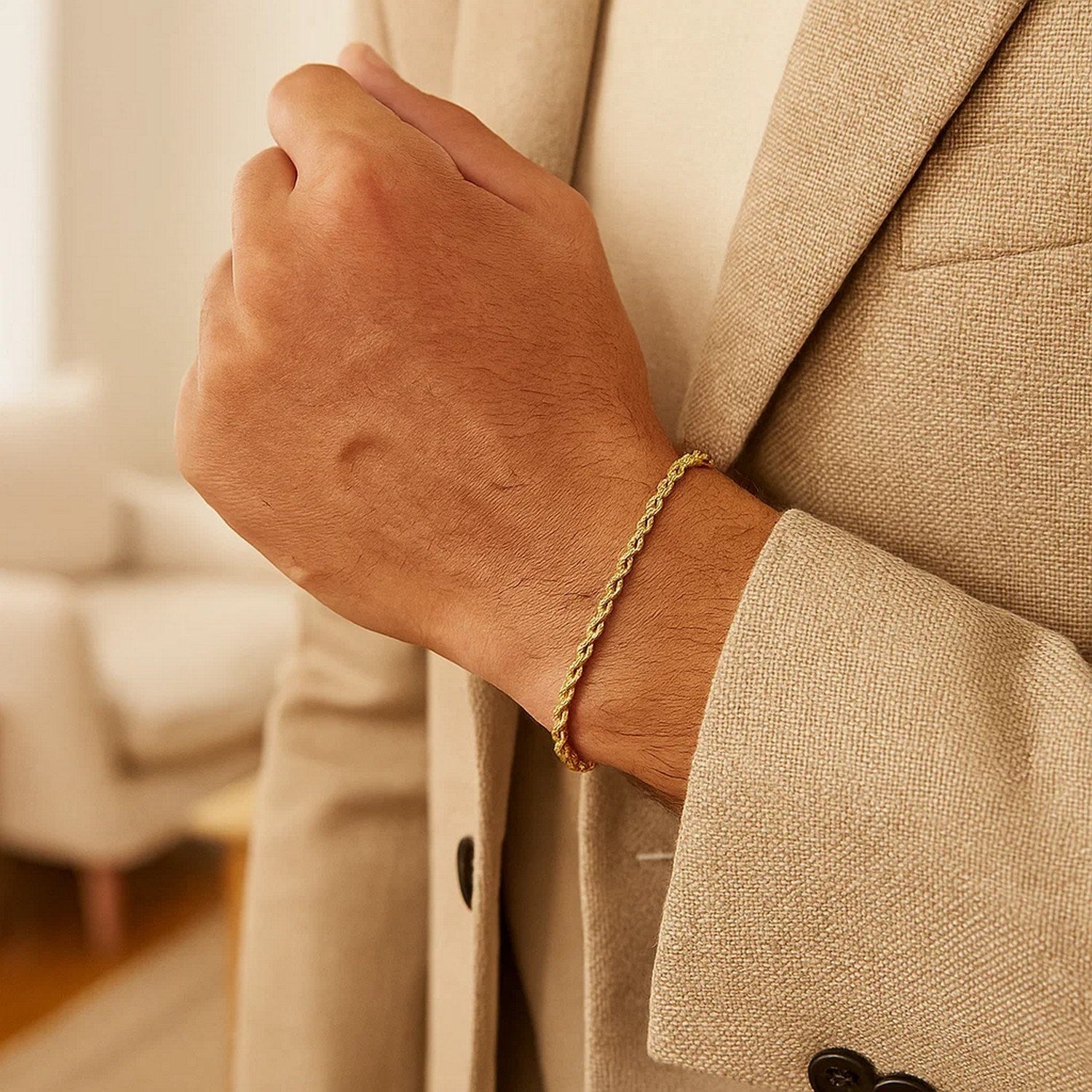 A 14k yellow gold silk rope chain bracelet on a person's wrist.
